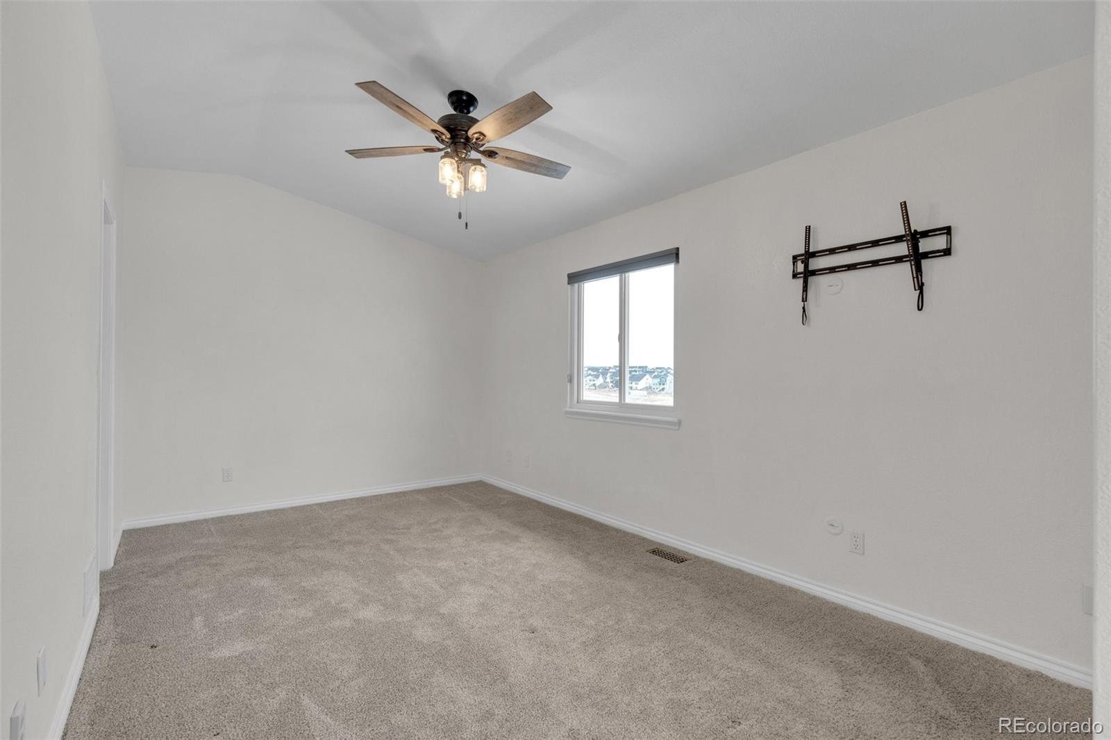 1227 Coronado Road Elizabeth, CO 80107 - Photo 17 of 45 a view of a room with a fan and a window