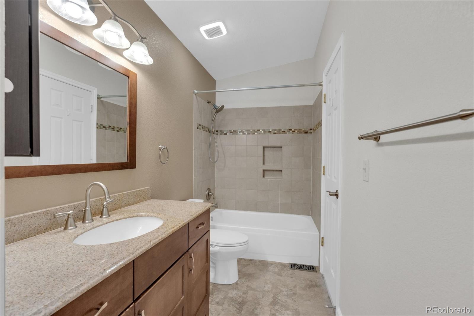1227 Coronado Road Elizabeth, CO 80107 - Photo 19 of 45 a bathroom with a granite countertop sink toilet and shower