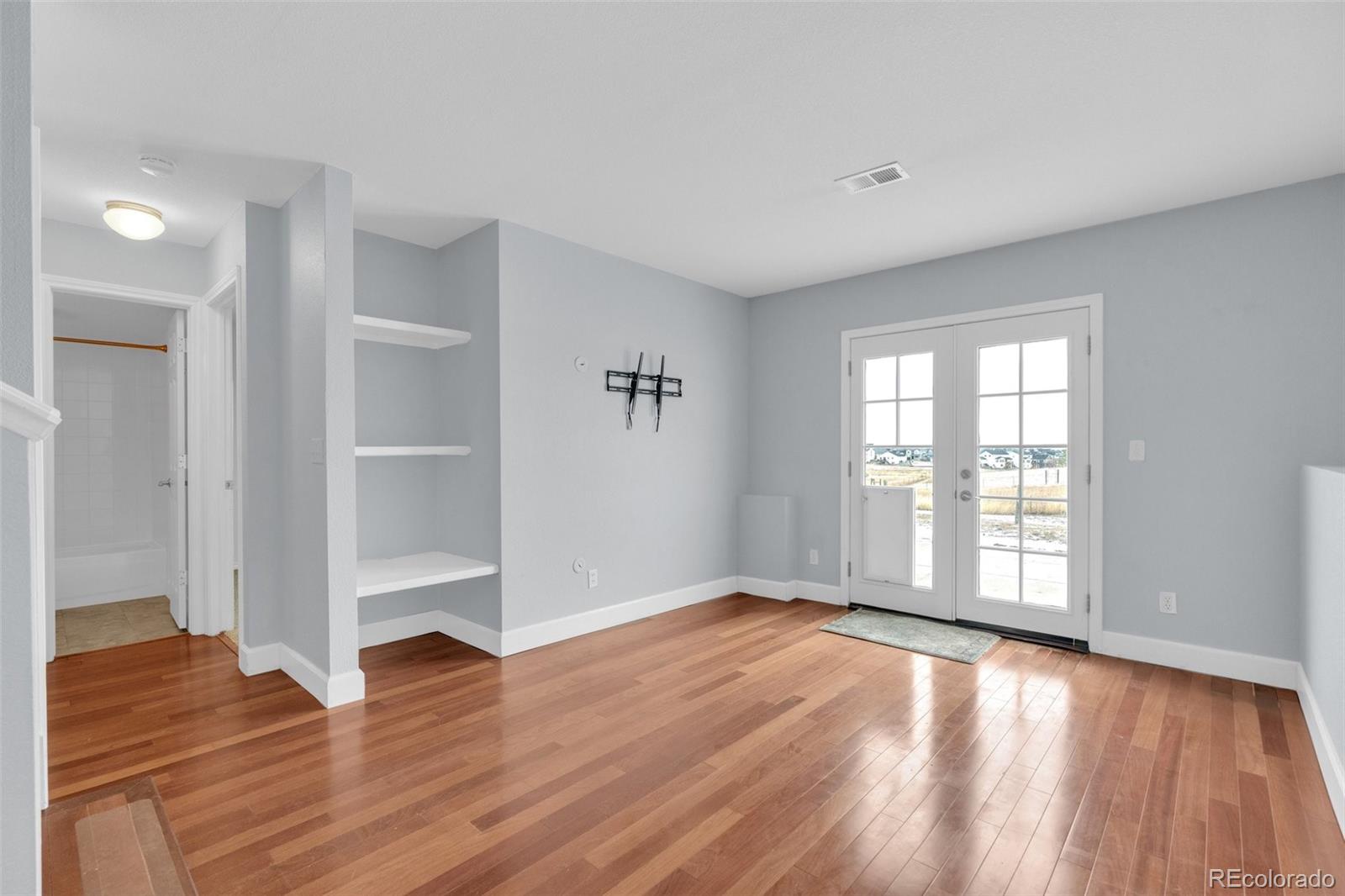 1227 Coronado Road Elizabeth, CO 80107 - Photo 28 of 45 wooden floor in an empty room with a window