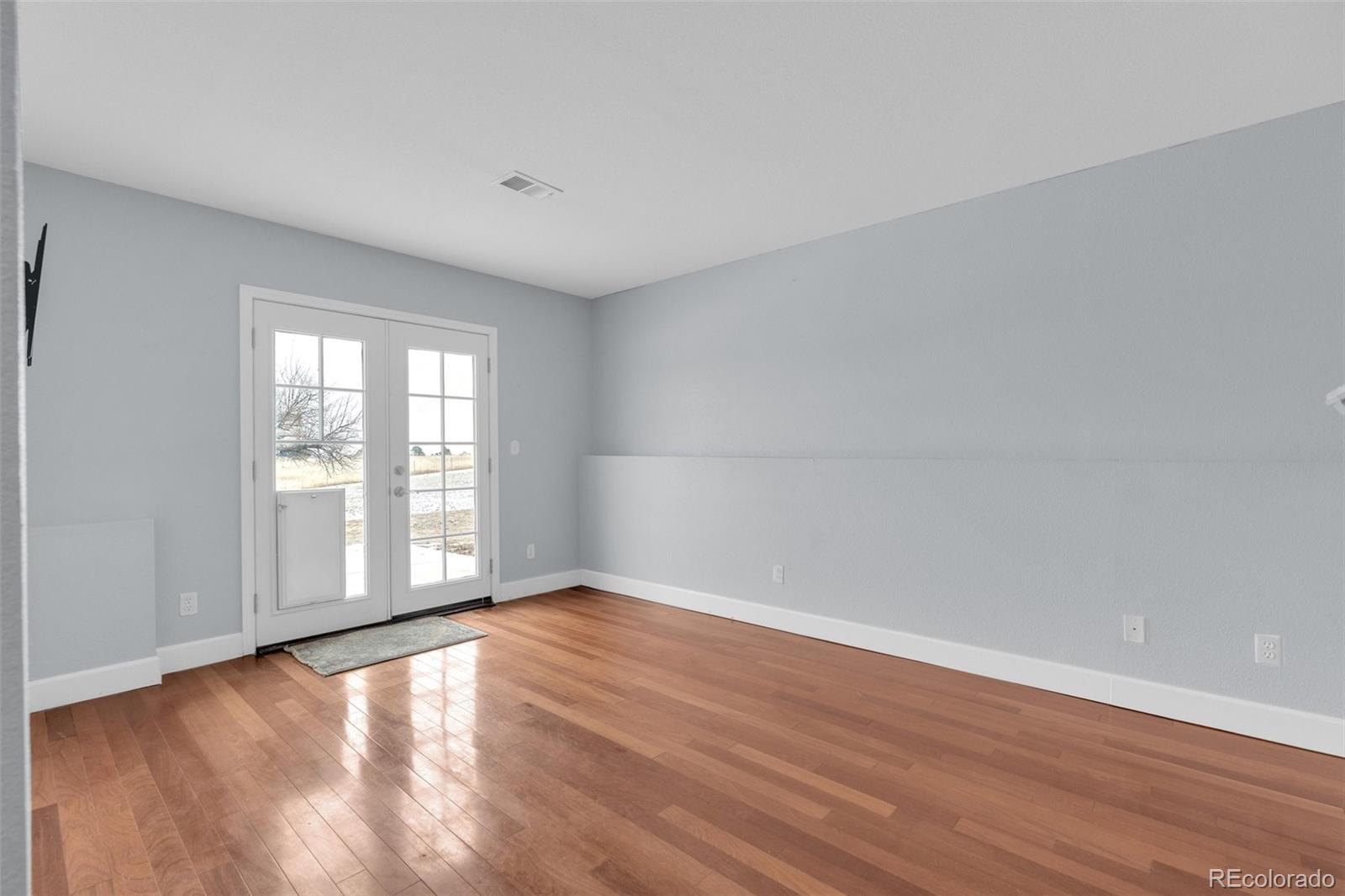 1227 Coronado Road Elizabeth, CO 80107 - Photo 29 of 45 a view of an empty room with wooden floor and a window