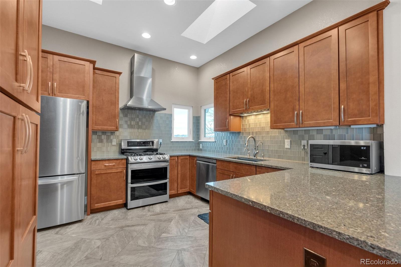 1227 Coronado Road Elizabeth, CO 80107 - Photo 3 of 45 a kitchen with granite countertop a refrigerator oven a sink and dishwasher