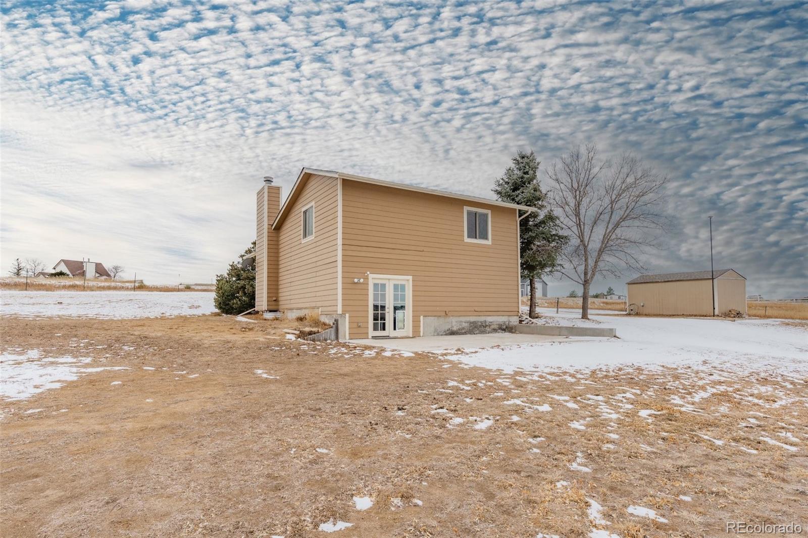 1227 Coronado Road Elizabeth, CO 80107 - Photo 36 of 45 a view of large house with a snow on the road