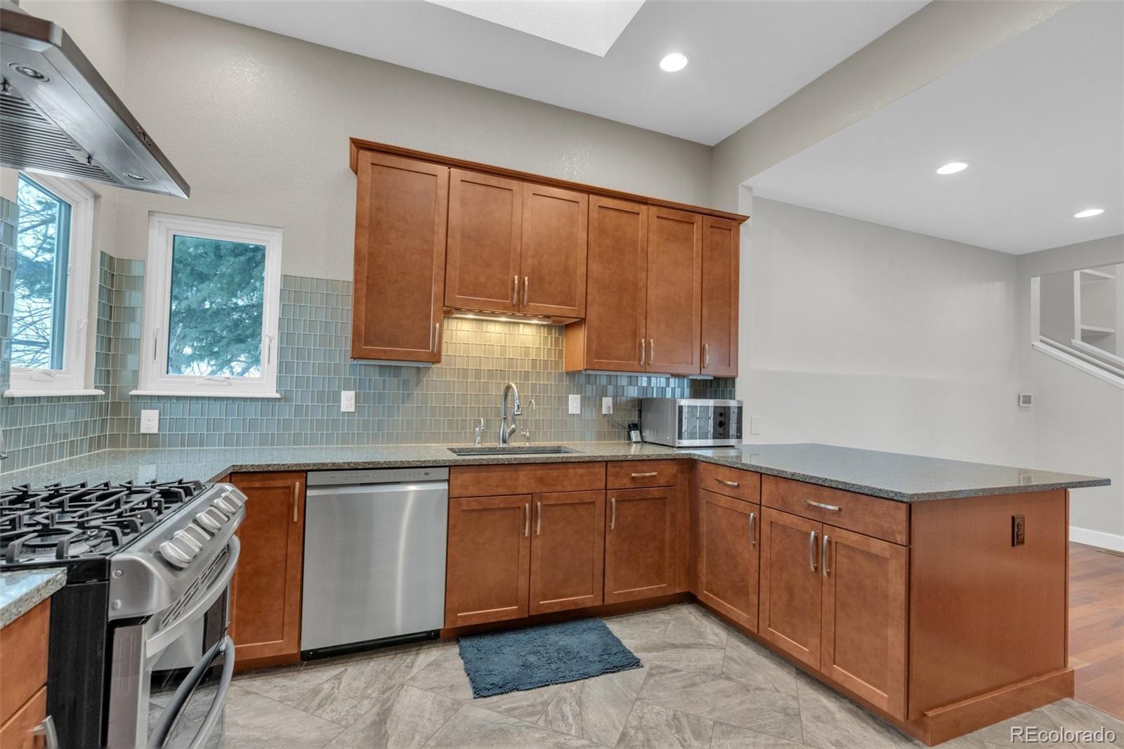 1227 Coronado Road Elizabeth, CO 80107 - Photo 4 of 45 a kitchen with a sink stove and cabinets