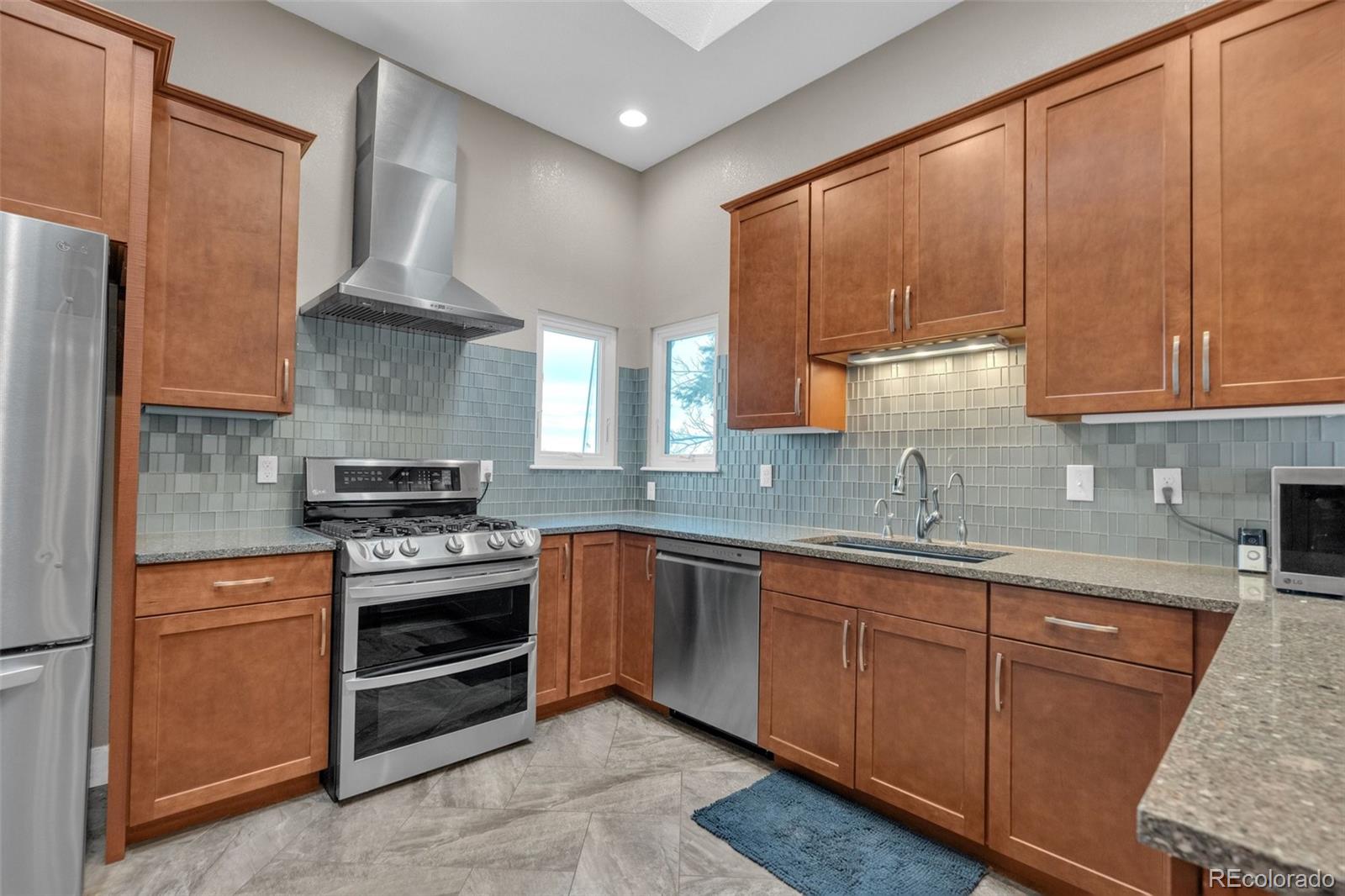 1227 Coronado Road Elizabeth, CO 80107 - Photo 5 of 45 a kitchen with stainless steel appliances granite countertop a sink stove and refrigerator