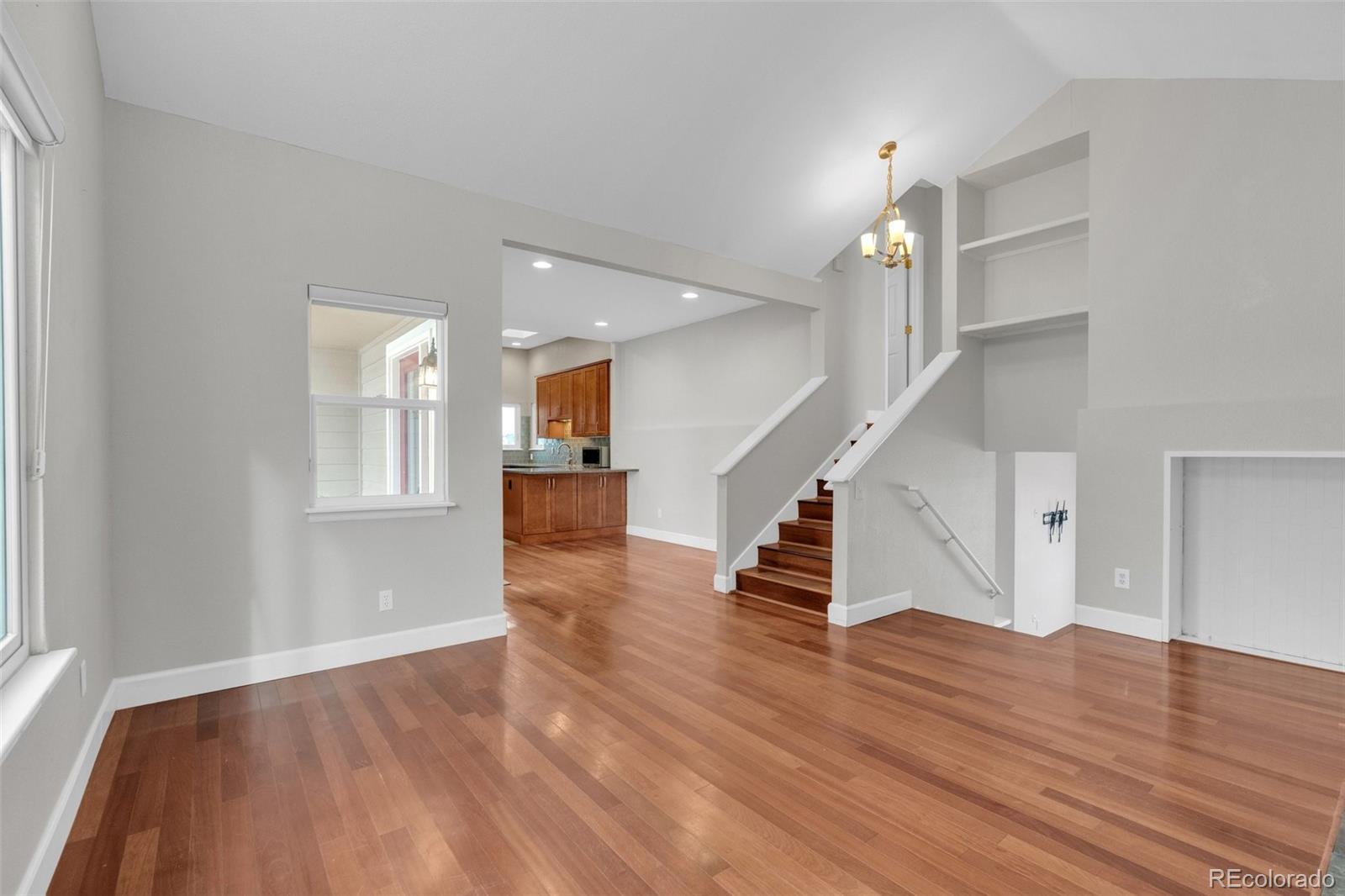 1227 Coronado Road Elizabeth, CO 80107 - Photo 7 of 45 an empty room with wooden floor and staircase