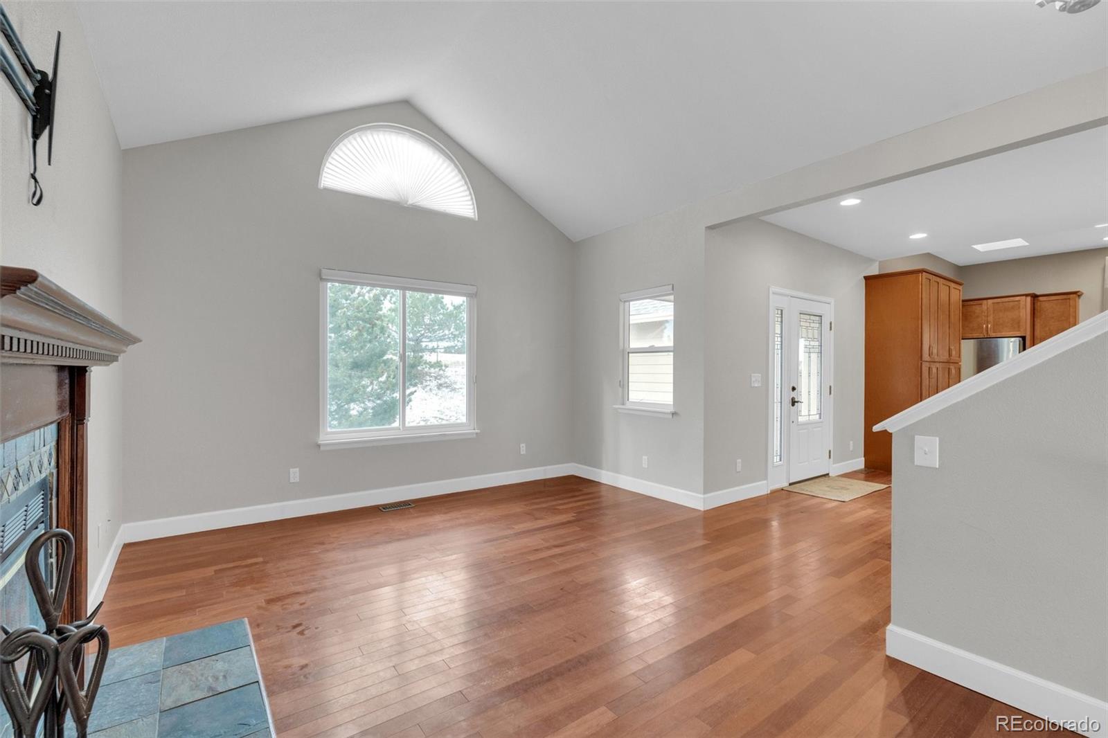 1227 Coronado Road Elizabeth, CO 80107 - Photo 8 of 45 a view of an empty room with window and wooden floor