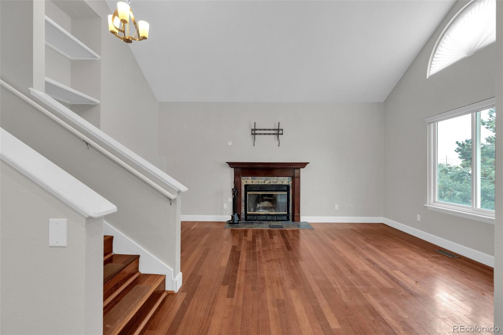 1227 Coronado Road Elizabeth, CO 80107 - Photo 10 of 45 a view of an empty room with wooden floor fireplace and a window