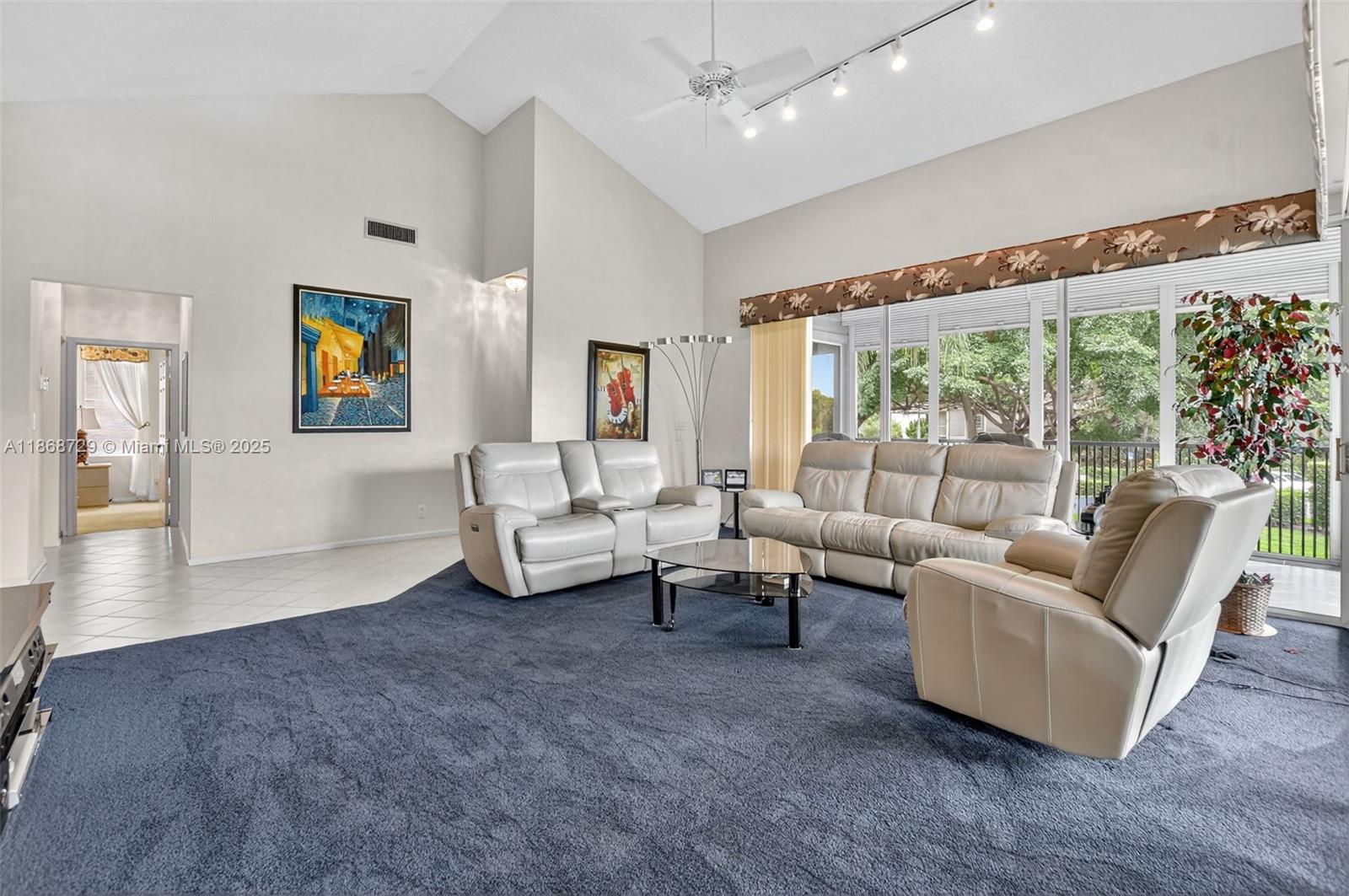 7596 Elm Ridge Drive, Unit 2U Boca Raton, FL 33433 - Photo 11 of 45 a living room with furniture and a large window