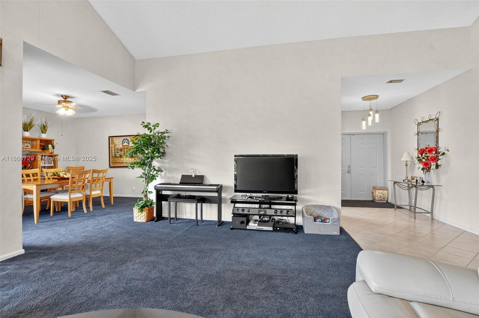 7596 Elm Ridge Drive, Unit 2U Boca Raton, FL 33433 - Photo 12 of 45 a living room with furniture and a flat screen tv