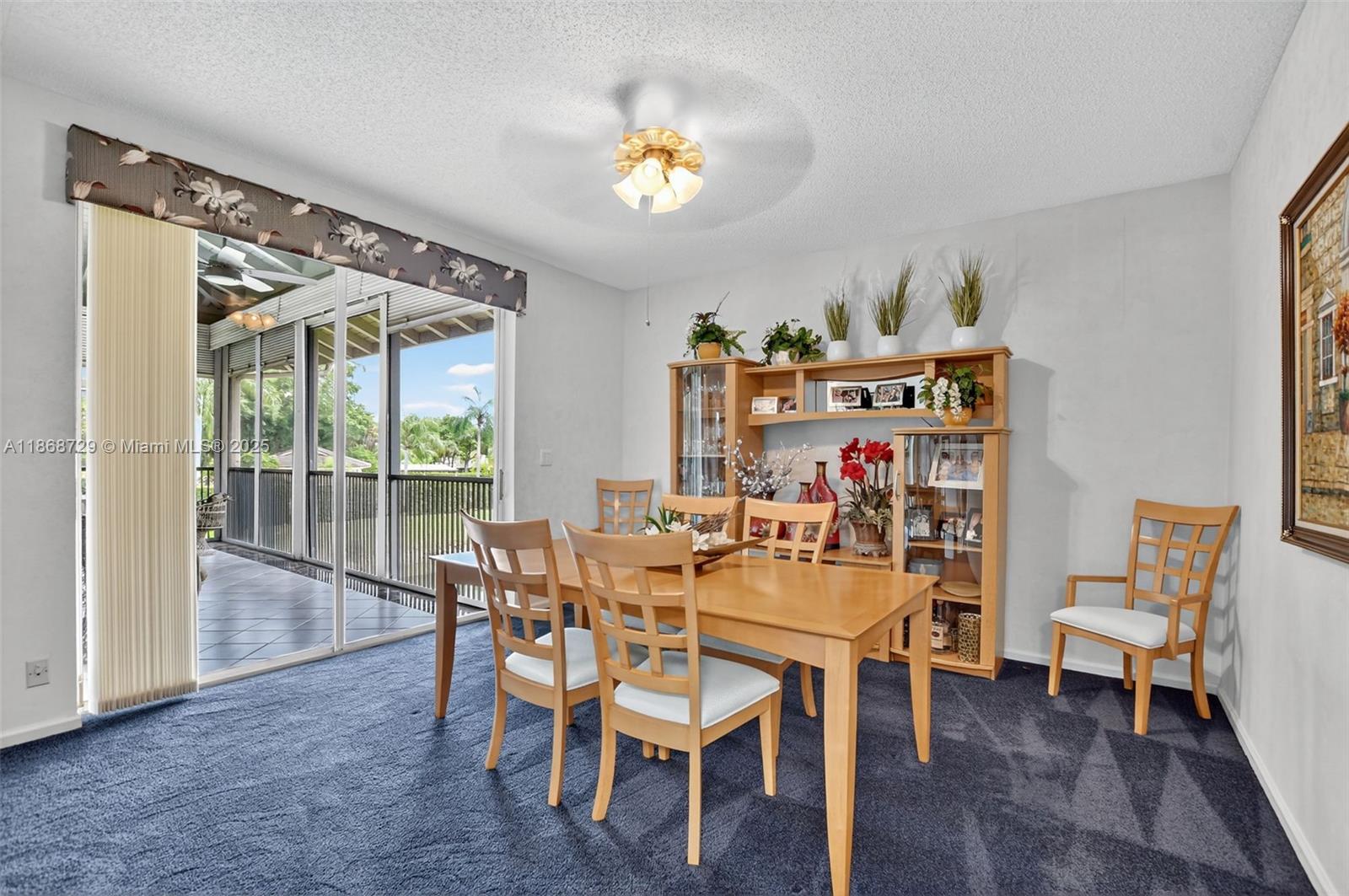 7596 Elm Ridge Drive, Unit 2U Boca Raton, FL 33433 - Photo 13 of 45 a dining room with furniture a rug and a chandelier