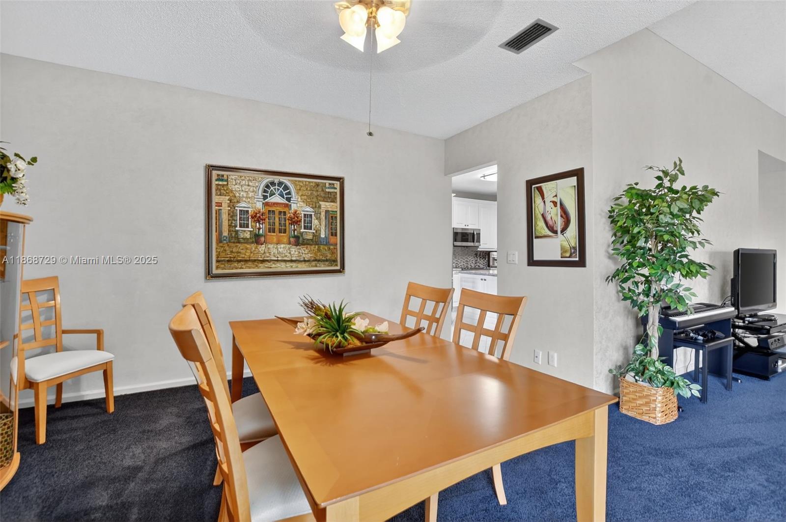 7596 Elm Ridge Drive, Unit 2U Boca Raton, FL 33433 - Photo 14 of 45 a view of a dining room with furniture and wooden floor