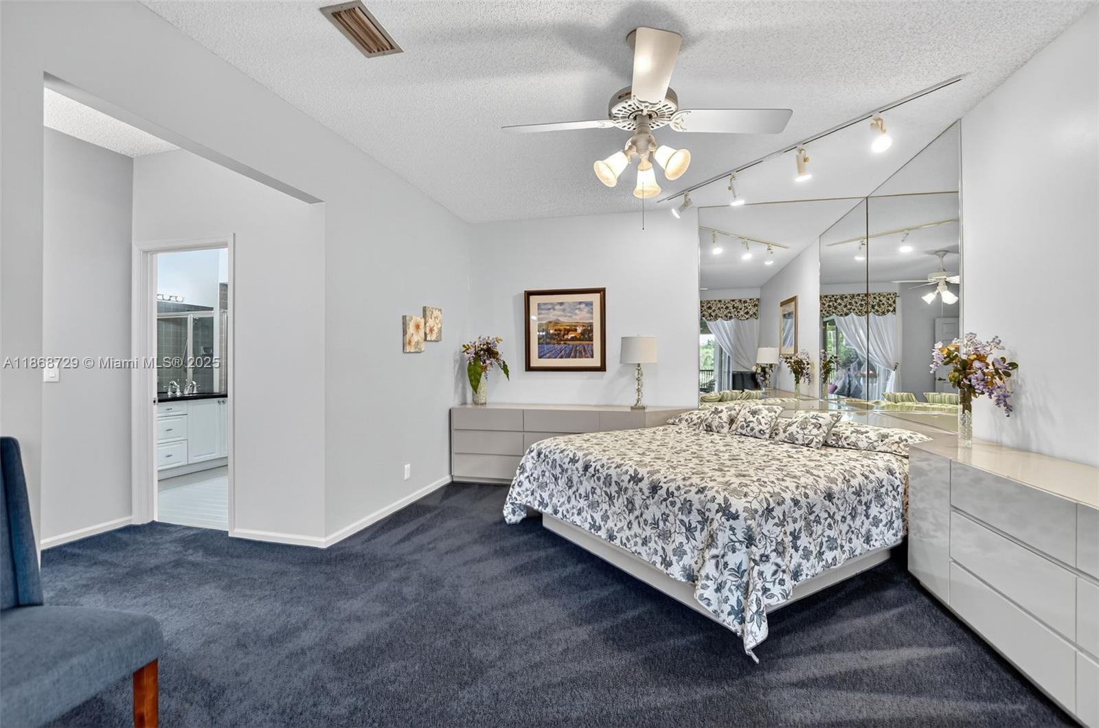 7596 Elm Ridge Drive, Unit 2U Boca Raton, FL 33433 - Photo 17 of 45 a living room with a bed and a chandelier