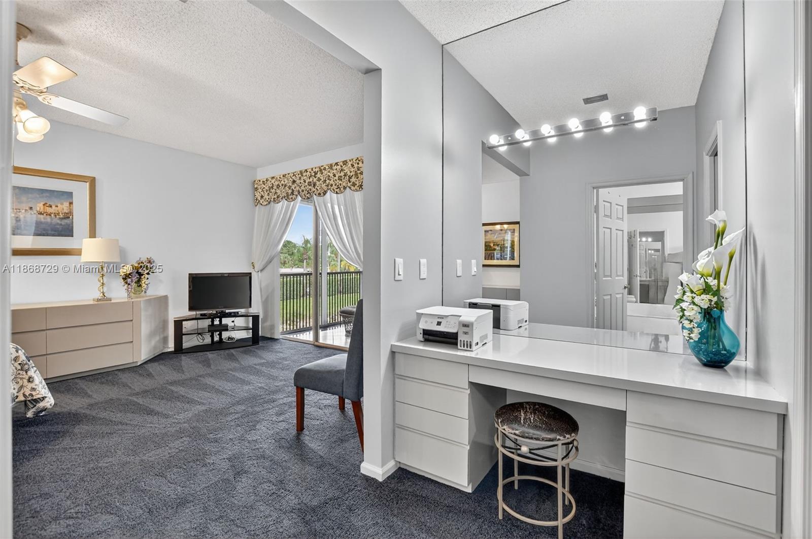 7596 Elm Ridge Drive, Unit 2U Boca Raton, FL 33433 - Photo 19 of 45 a living room with furniture a flat screen tv and a large window