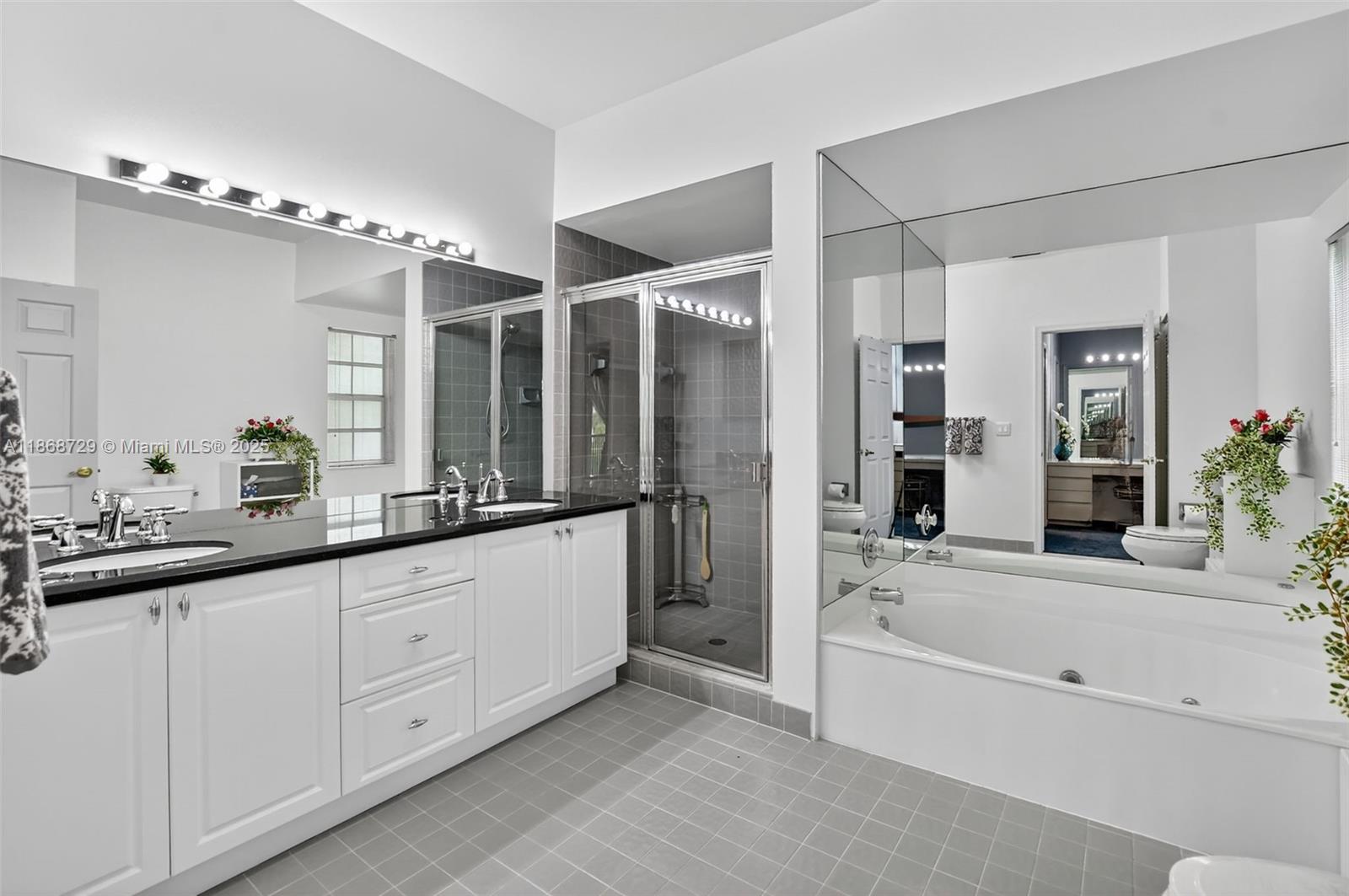7596 Elm Ridge Drive, Unit 2U Boca Raton, FL 33433 - Photo 20 of 45 a bathroom with a tub a sink and mirror