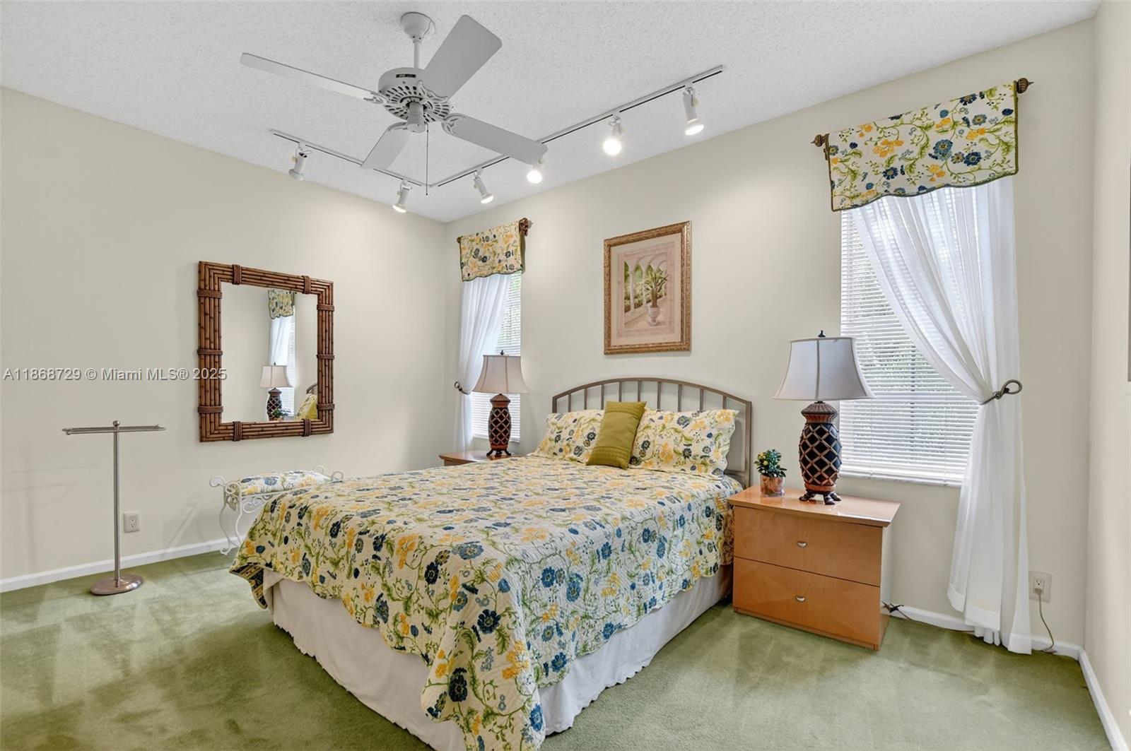 7596 Elm Ridge Drive, Unit 2U Boca Raton, FL 33433 - Photo 23 of 45 a bedroom with a bed and a chandelier