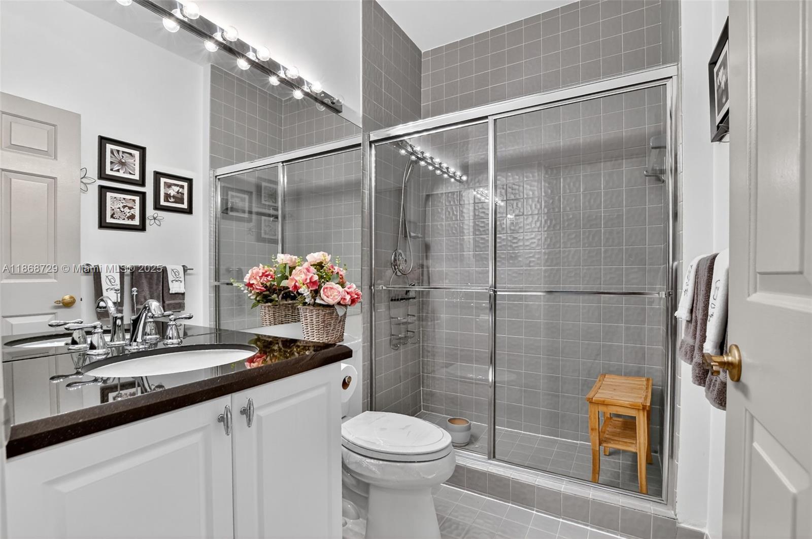 7596 Elm Ridge Drive, Unit 2U Boca Raton, FL 33433 - Photo 25 of 45 a bathroom with a sink toilet and shower