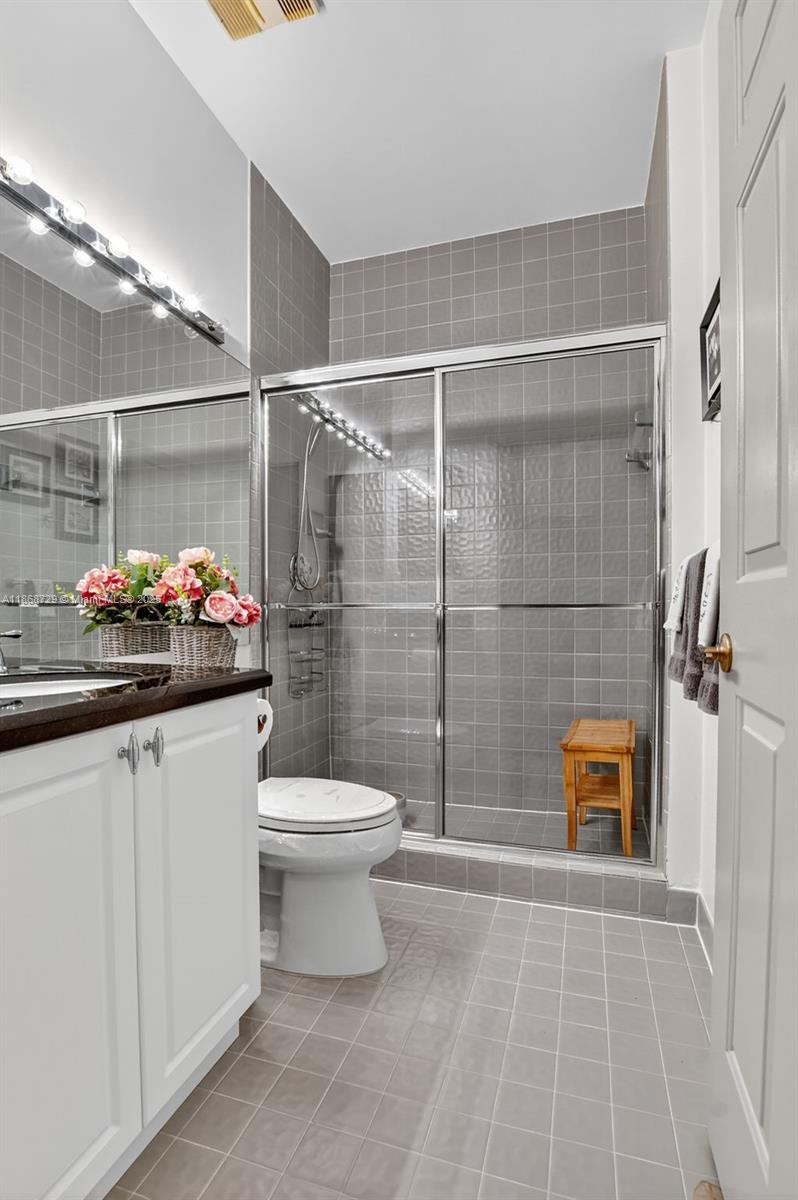 7596 Elm Ridge Drive, Unit 2U Boca Raton, FL 33433 - Photo 26 of 45 a bathroom with a toilet sink and shower