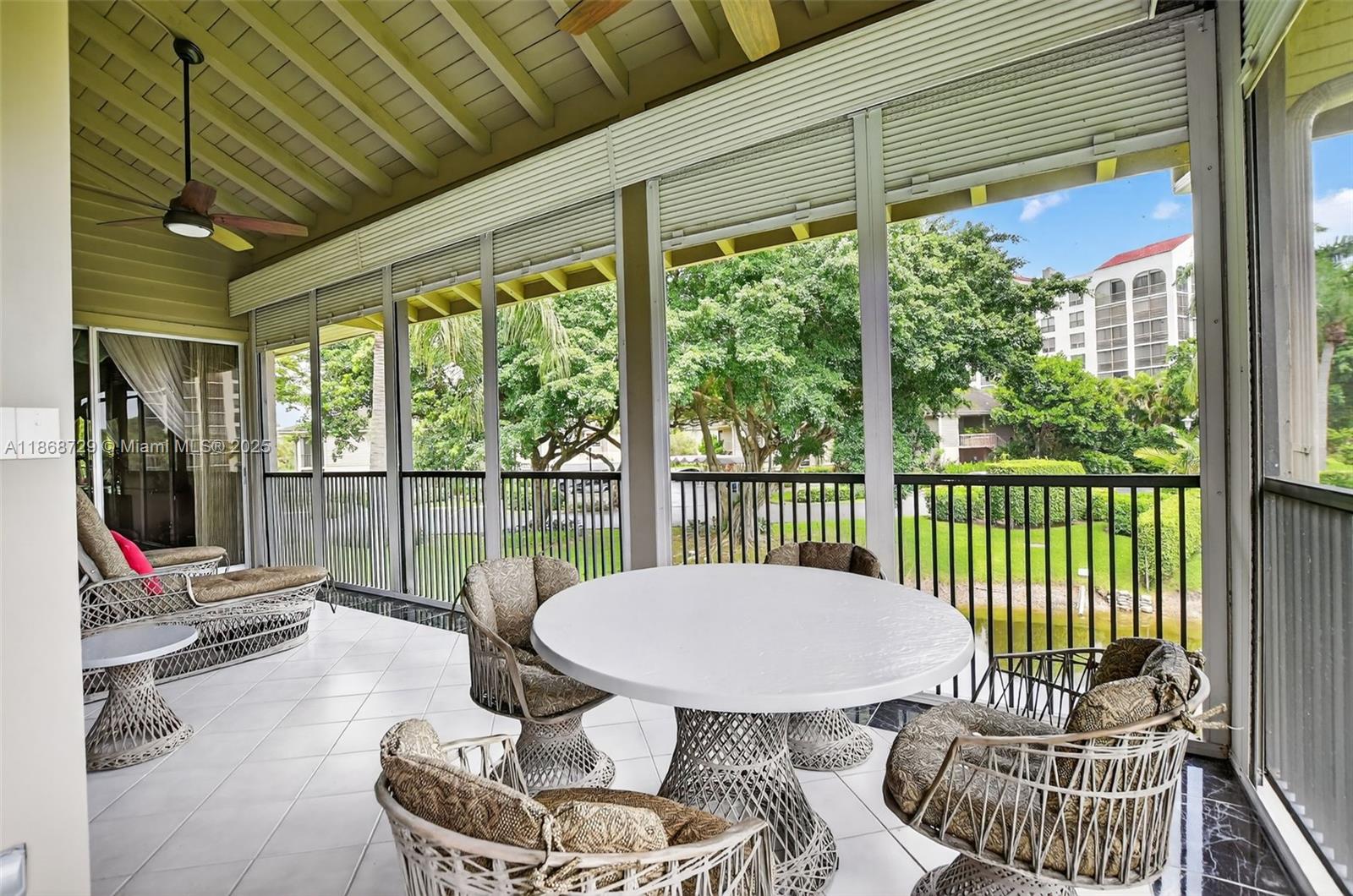 7596 Elm Ridge Drive, Unit 2U Boca Raton, FL 33433 - Photo 29 of 45 a view of a balcony with chair and glass door