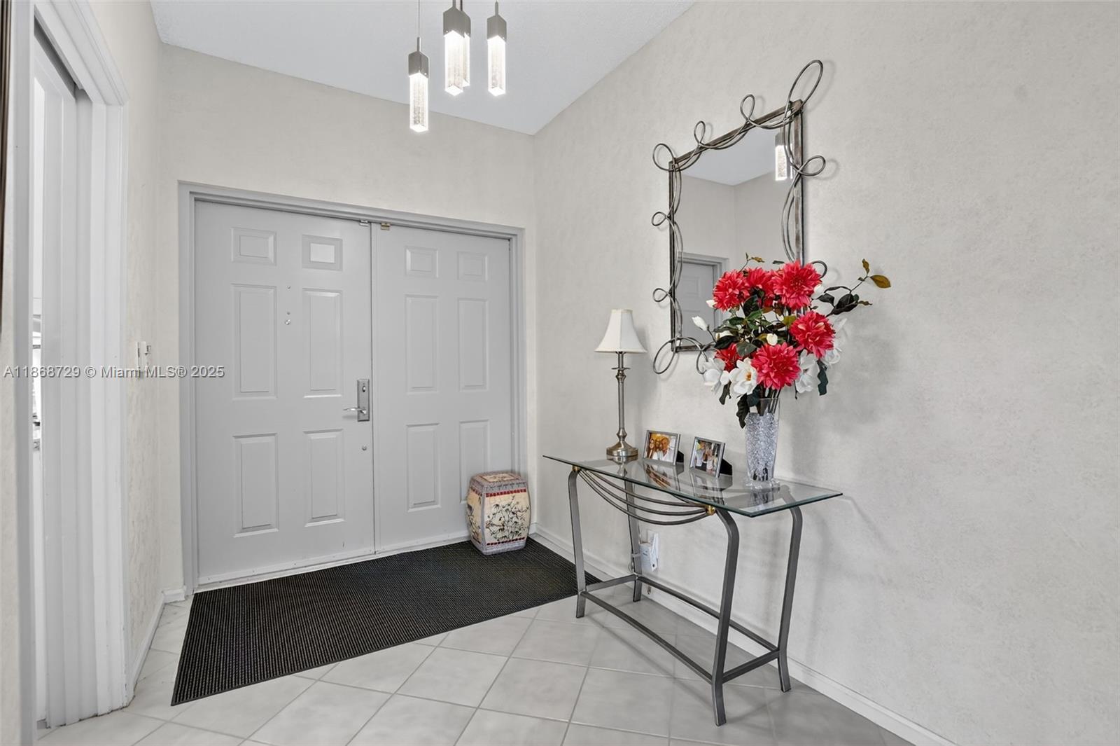 7596 Elm Ridge Drive, Unit 2U Boca Raton, FL 33433 - Photo 3 of 45 a view of a dining room and chandelier fan