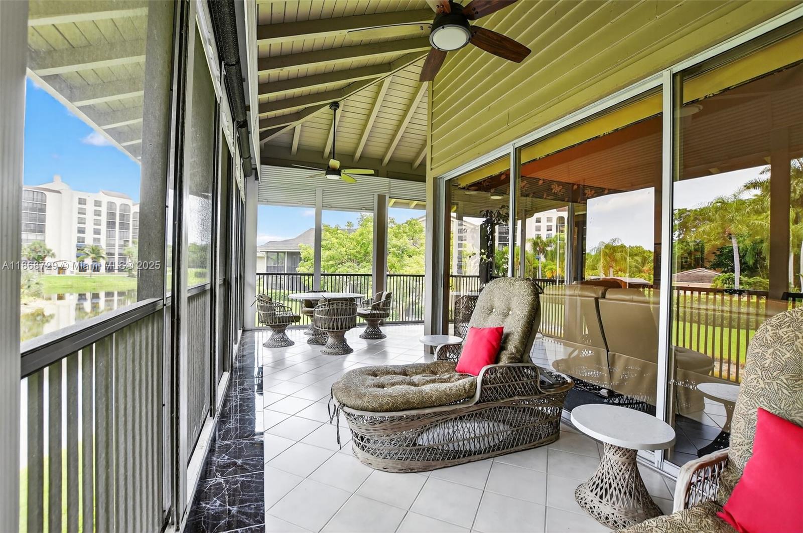 7596 Elm Ridge Drive, Unit 2U Boca Raton, FL 33433 - Photo 31 of 45 a living room with furniture and floor to ceiling windows