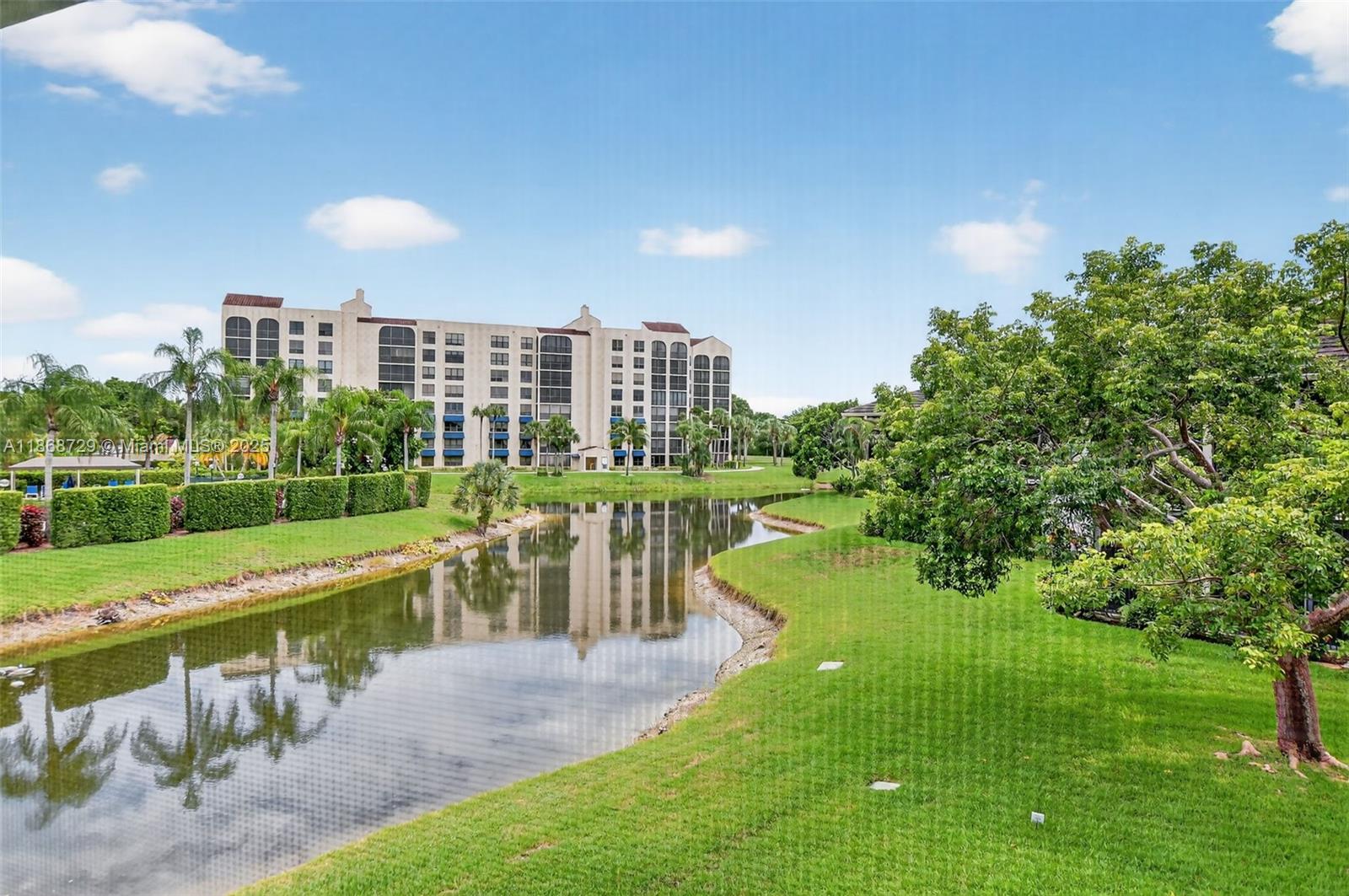 7596 Elm Ridge Drive, Unit 2U Boca Raton, FL 33433 - Photo 33 of 45 a view of a lake with a building in the background