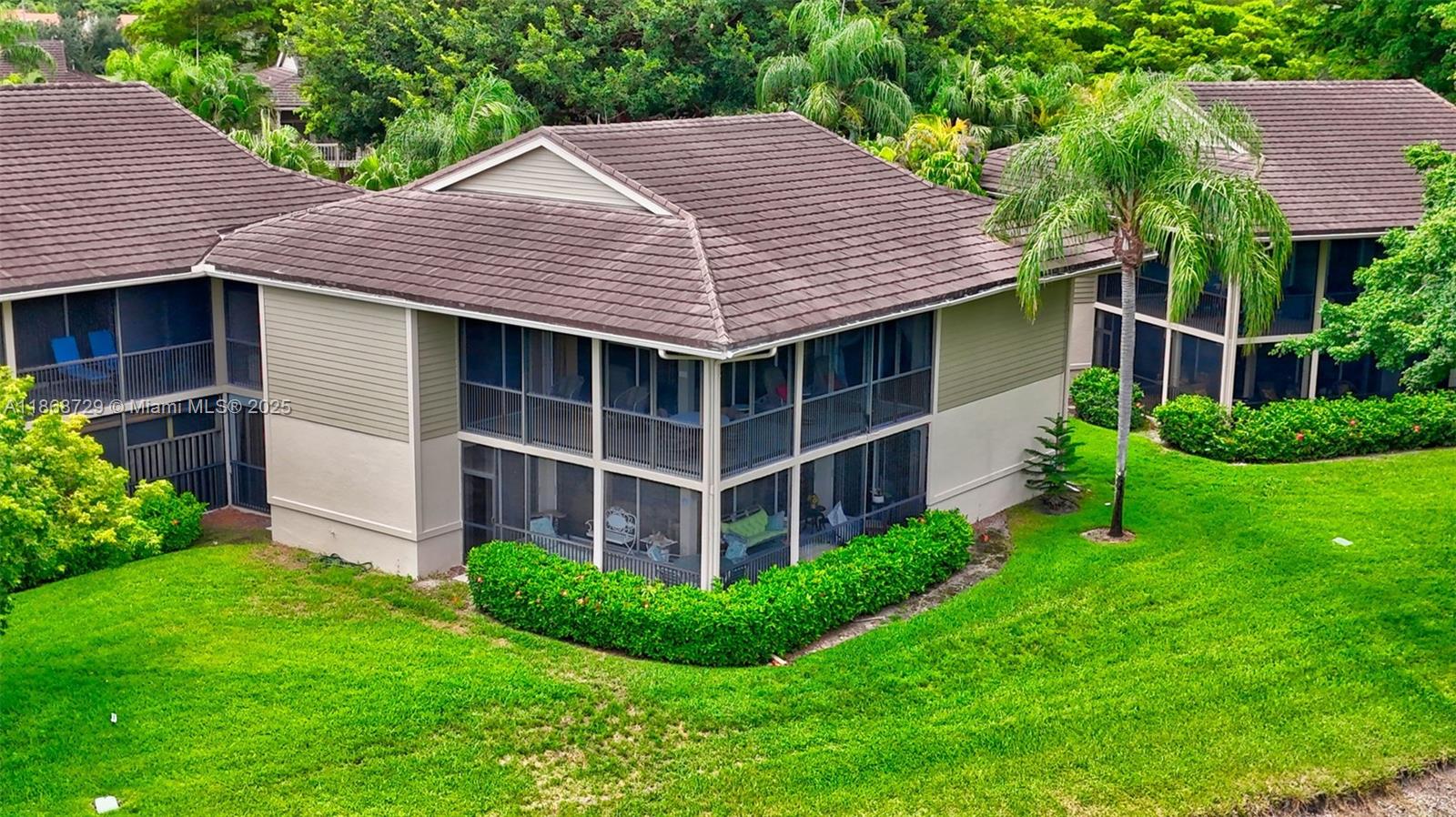 7596 Elm Ridge Drive, Unit 2U Boca Raton, FL 33433 - Photo 36 of 45 a view of a house with brick walls and a yard with plants