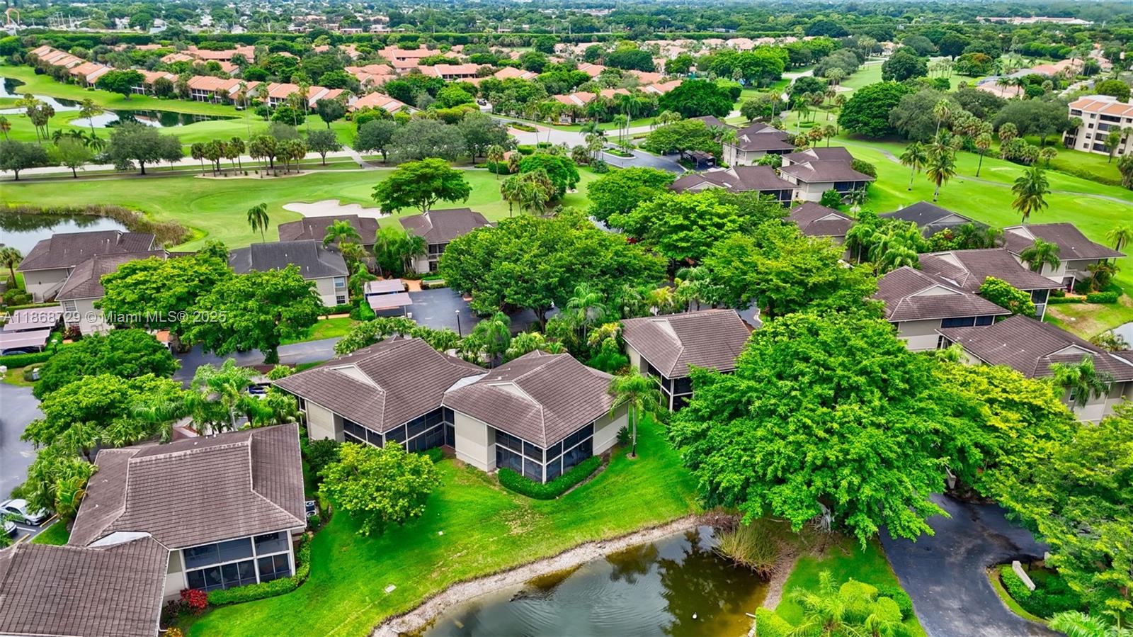 7596 Elm Ridge Drive, Unit 2U Boca Raton, FL 33433 - Photo 44 of 45 an aerial view of house with yard swimming pool and outdoor seating