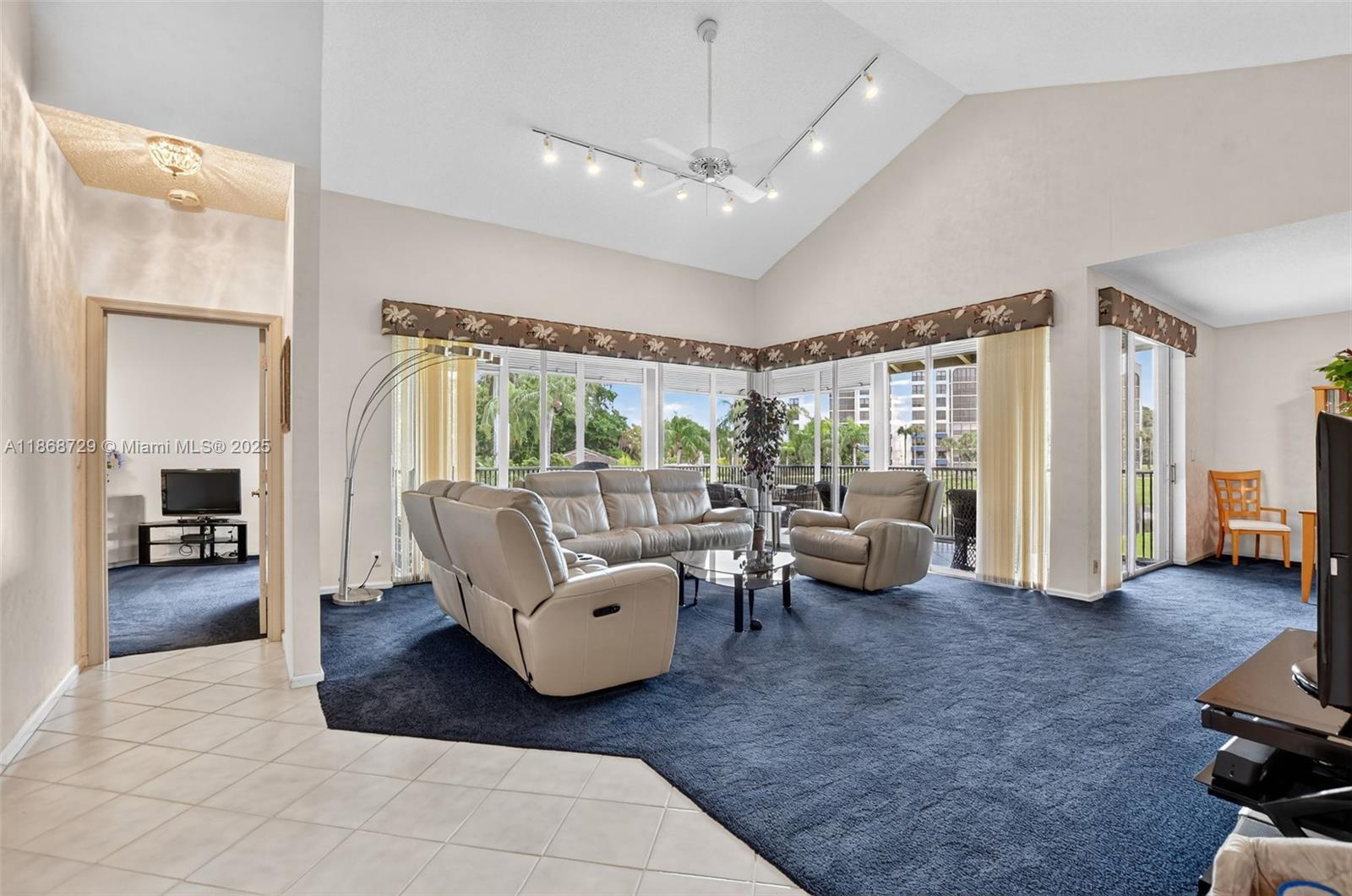 7596 Elm Ridge Drive, Unit 2U Boca Raton, FL 33433 - Photo 9 of 45 a living room with furniture and a large window