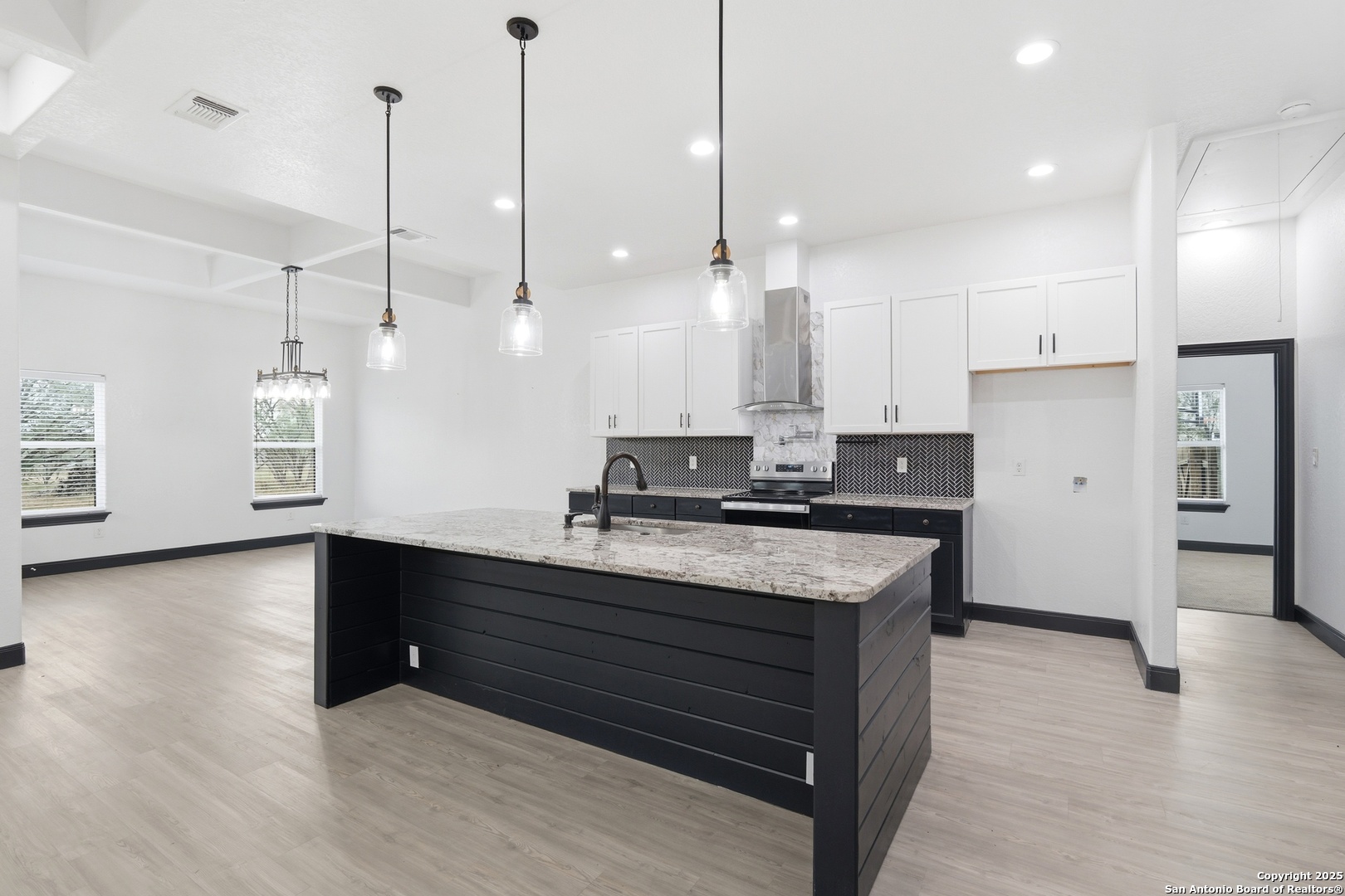 128 Hidden Ranch Court Floresville, TX 78114 - Photo 13 of 39 a kitchen with kitchen island a counter top space appliances and a ceiling fan