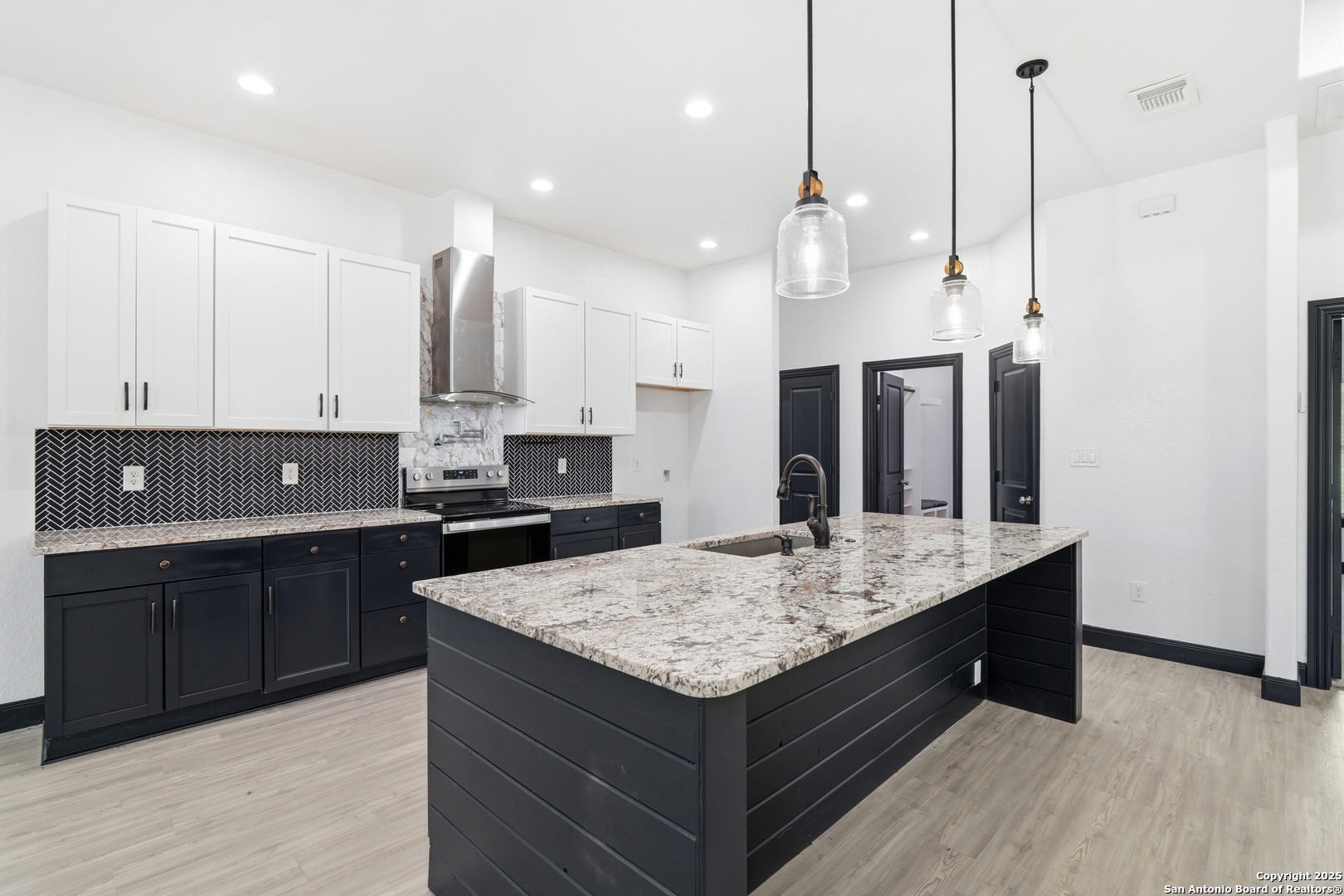 128 Hidden Ranch Court Floresville, TX 78114 - Photo 14 of 39 a kitchen with kitchen island granite countertop wooden cabinets and a sink
