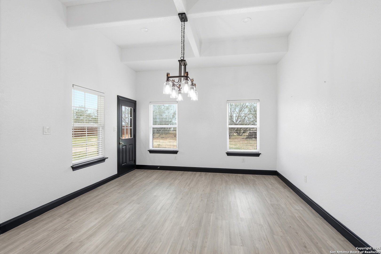 128 Hidden Ranch Court Floresville, TX 78114 - Photo 17 of 39 a view of an empty room with wooden floor and a window