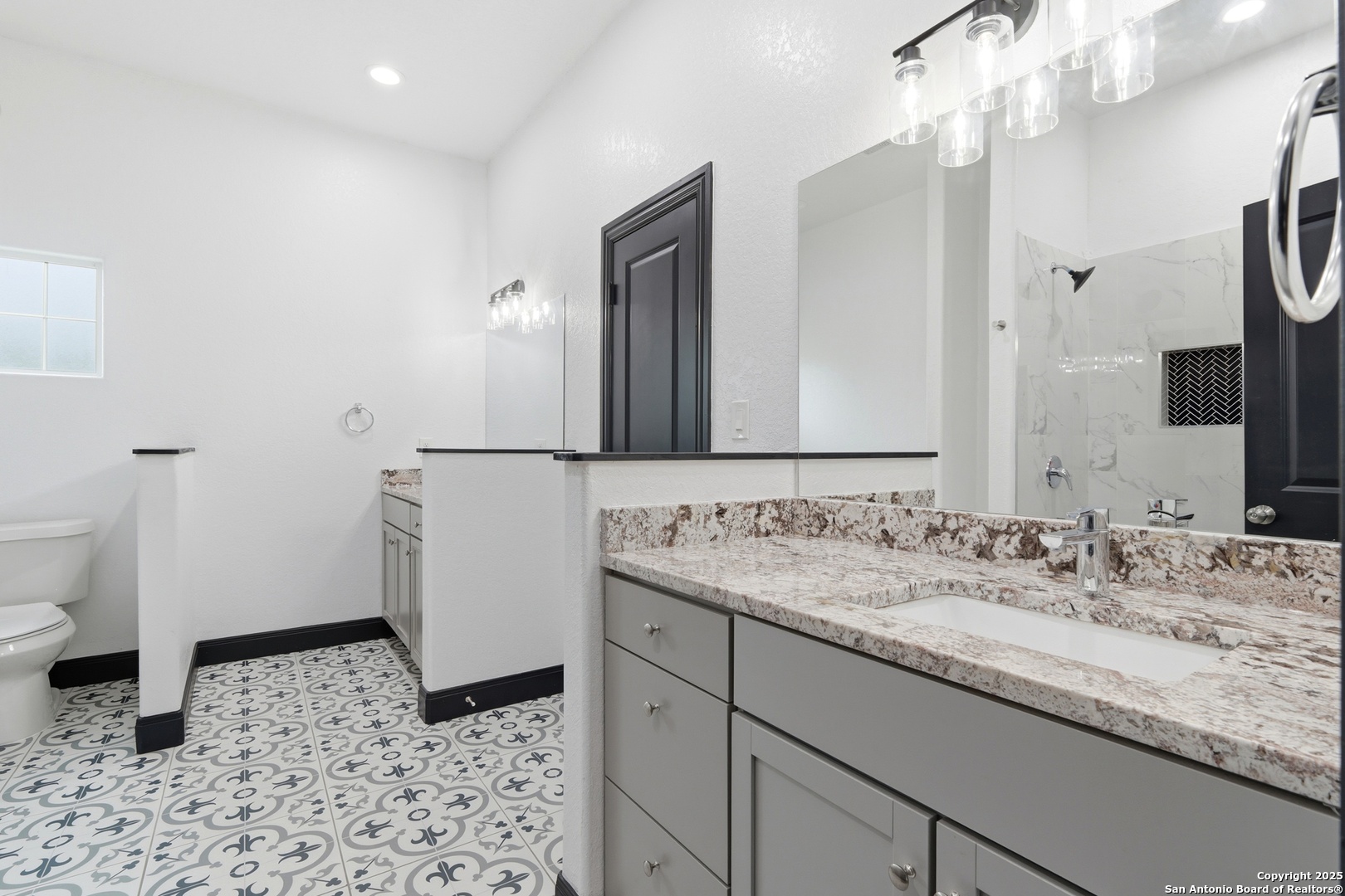 128 Hidden Ranch Court Floresville, TX 78114 - Photo 20 of 39 a bathroom with a sink a toilet and a mirror
