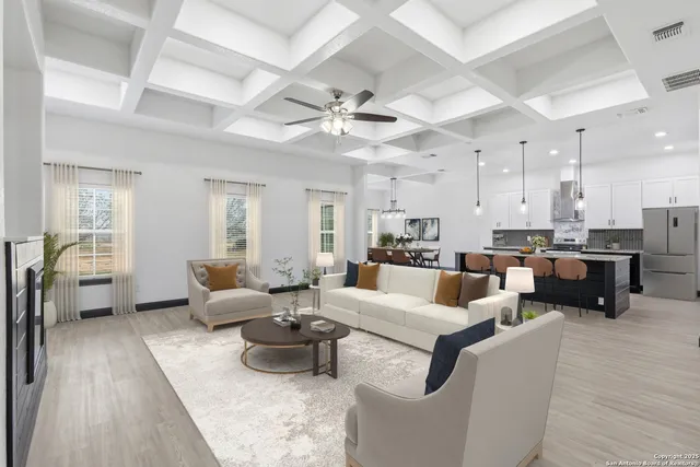a living room with furniture kitchen view and a large window