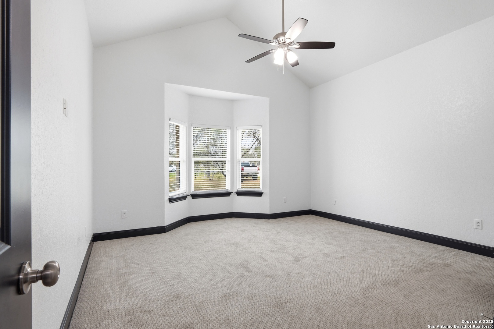 128 Hidden Ranch Court Floresville, TX 78114 - Photo 24 of 39 an empty room with windows and fan