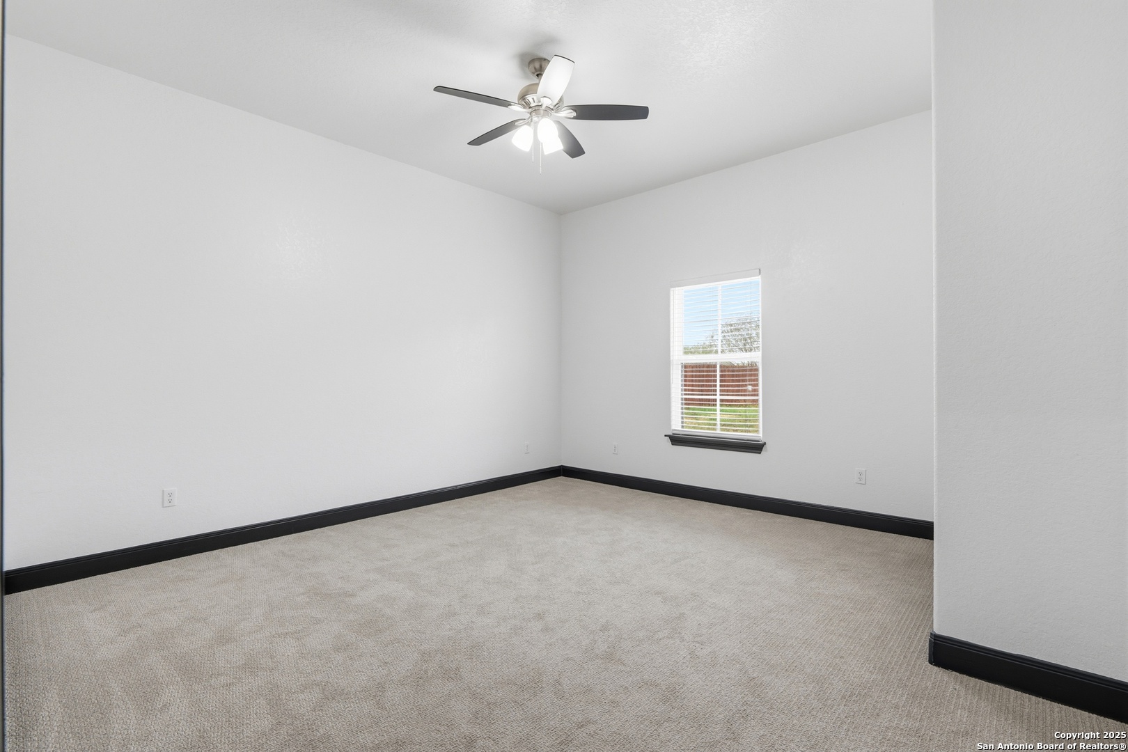 128 Hidden Ranch Court Floresville, TX 78114 - Photo 28 of 39 an empty room with a window and a ceiling fan
