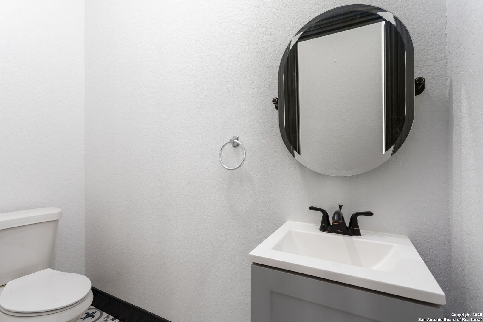 128 Hidden Ranch Court Floresville, TX 78114 - Photo 33 of 39 a bathroom with a sink and mirror with toilet