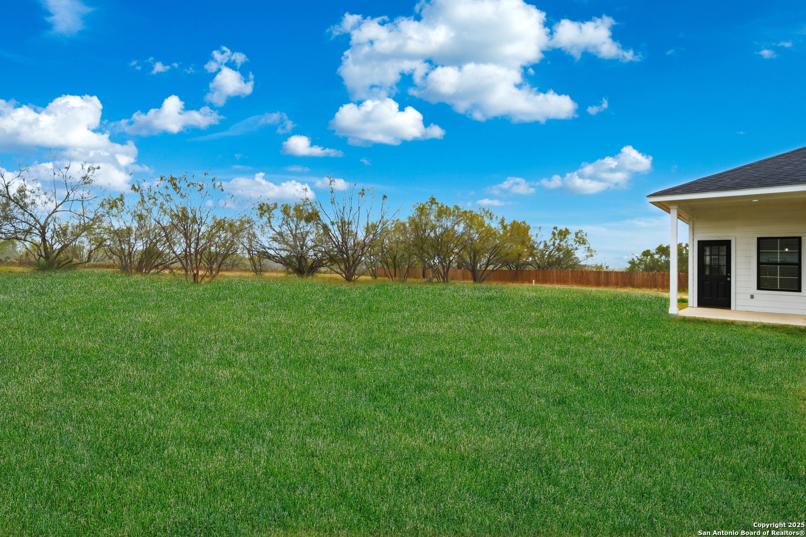 128 Hidden Ranch Court Floresville, TX 78114 - Photo 36 of 39 a view of a big yard with a house in the background
