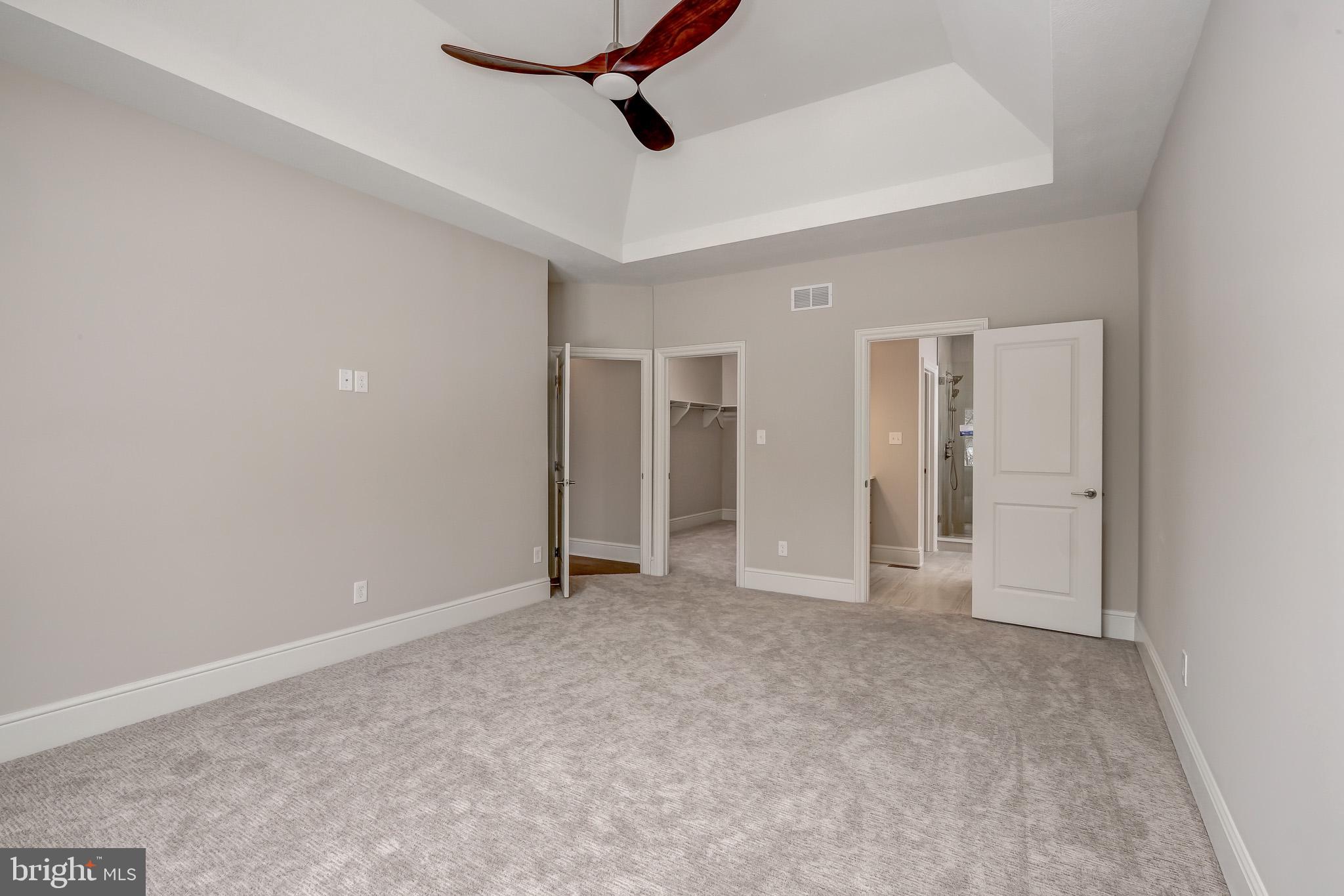 102 Harvey Road, Unit 1PS Wallingford, PA 19086 - Photo 12 of 18 a view of an empty room and chandelier fan