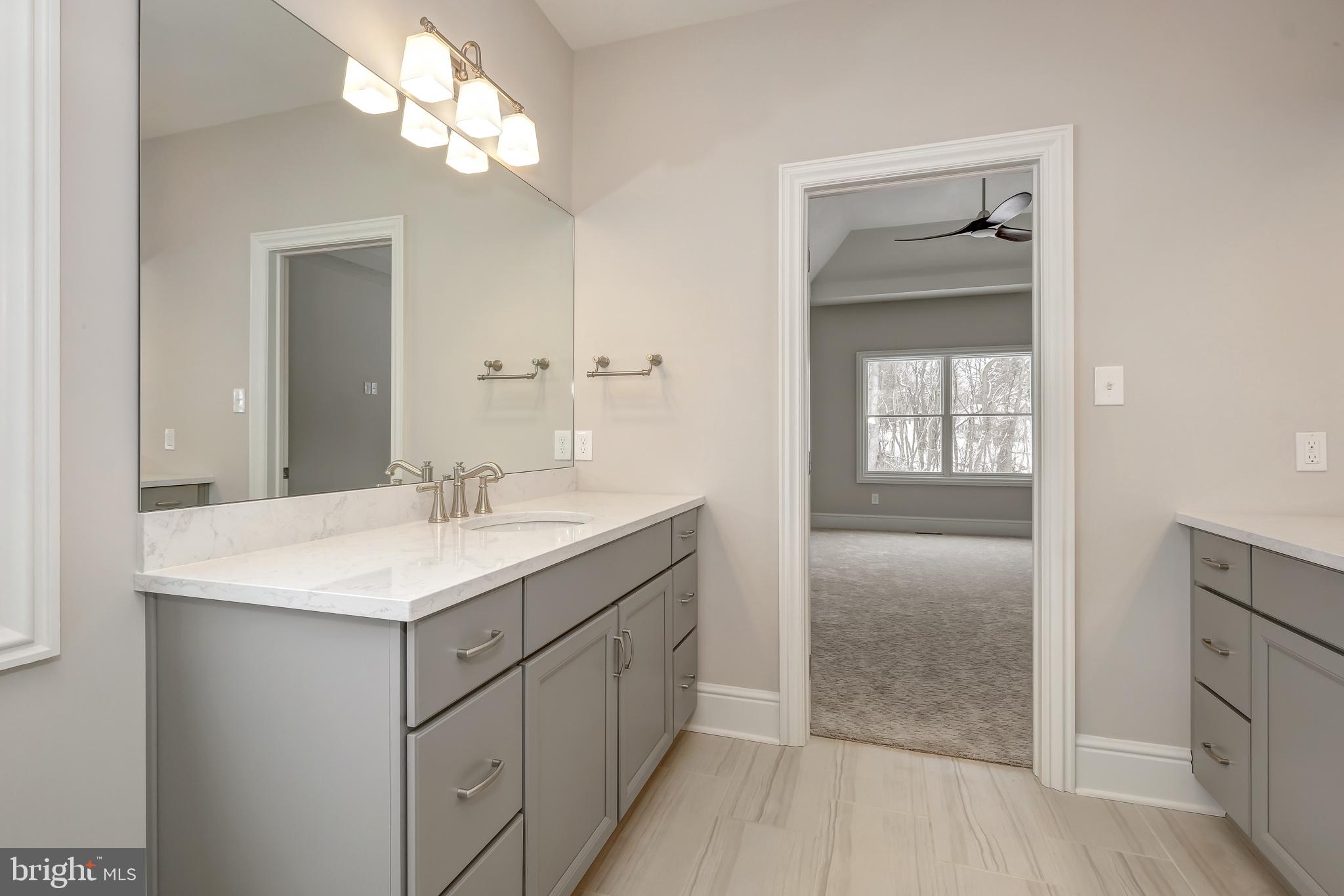 102 Harvey Road, Unit 1PS Wallingford, PA 19086 - Photo 14 of 18 a bathroom with a sink a light fixture and a mirror