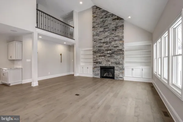 a view of an empty room with a fireplace and a window
