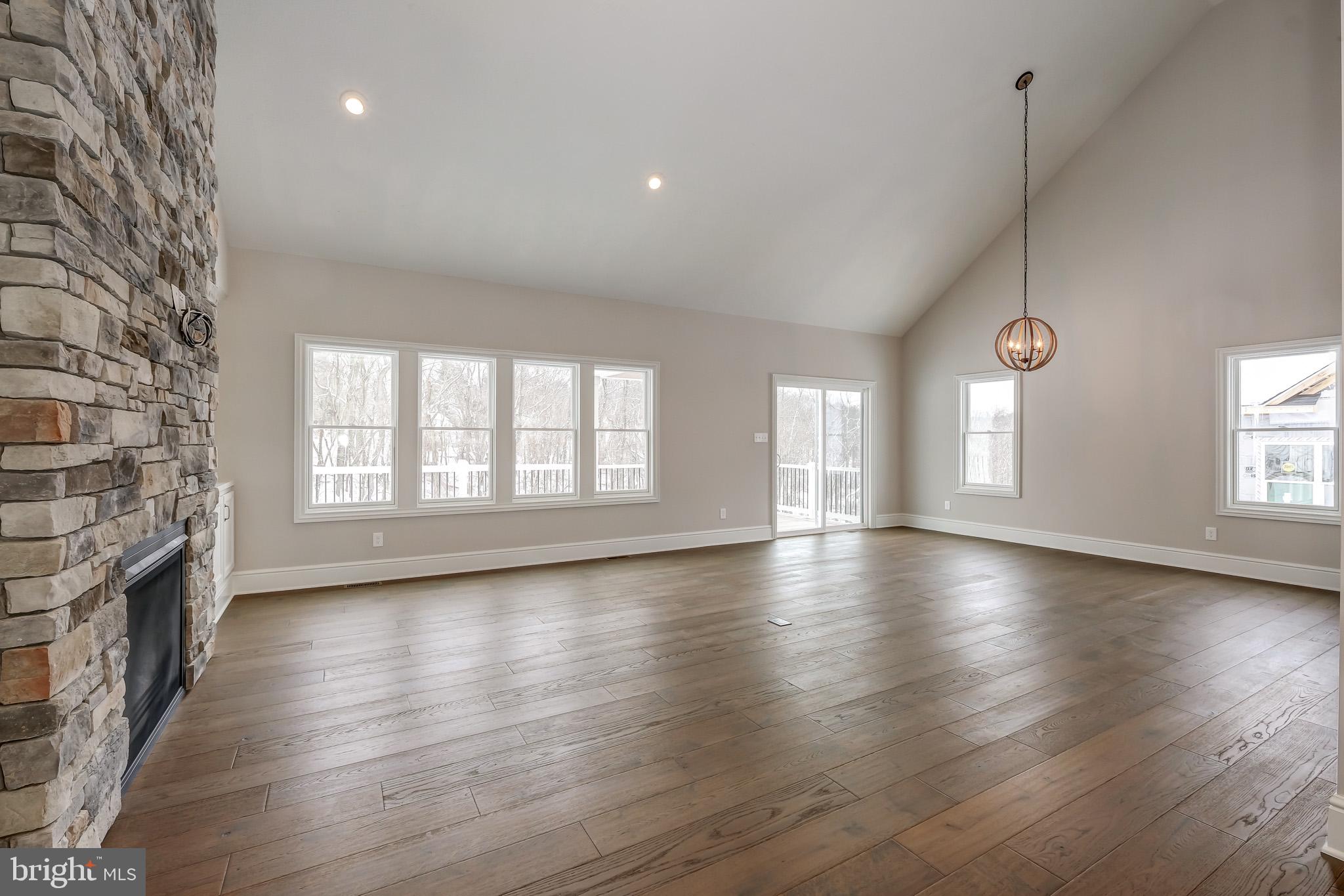102 Harvey Road, Unit 1PS Wallingford, PA 19086 - Photo 7 of 18 an empty room with wooden floor and windows
