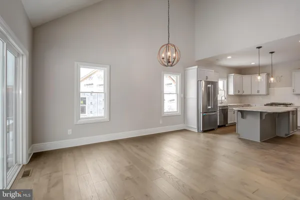 a view of kitchen with stove microwave and cabinets
