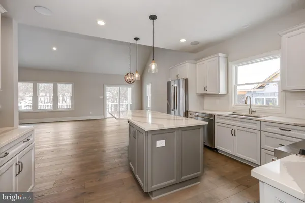 a kitchen with stainless steel appliances granite countertop a stove and a sink