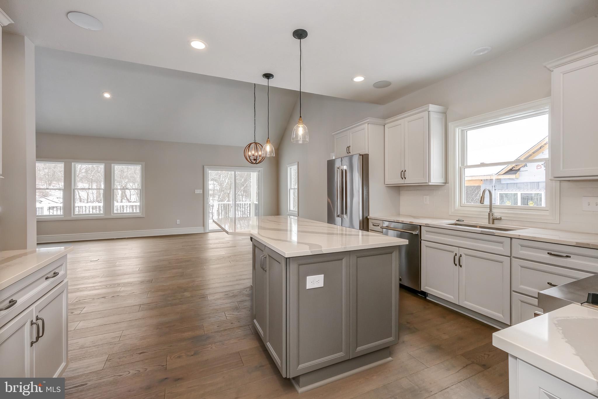102 Harvey Road, Unit 1PS Wallingford, PA 19086 - Photo 10 of 18 a kitchen with stainless steel appliances granite countertop a stove and a sink