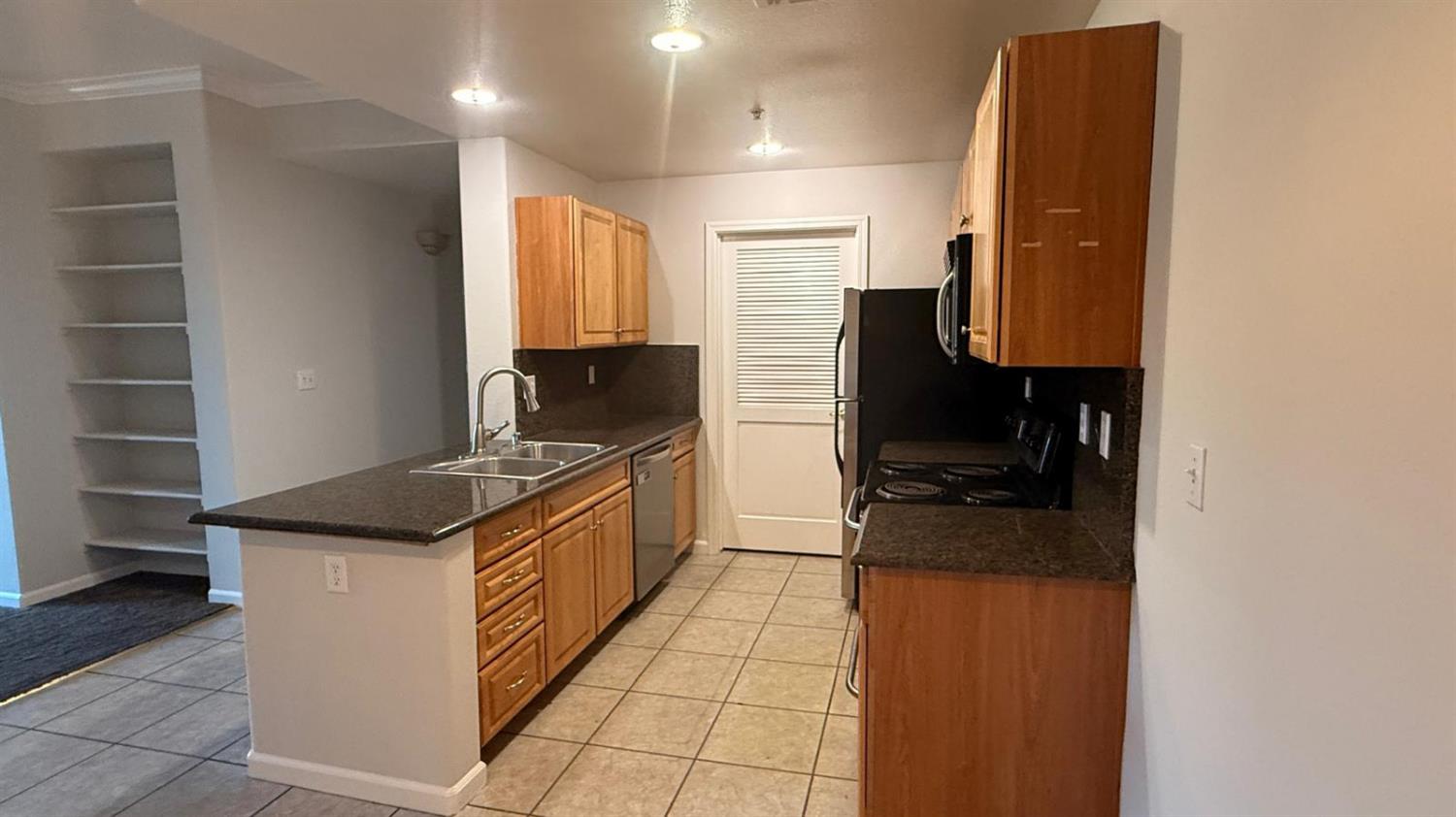 1360 Shady Lane, Unit 923 Turlock, CA 95382 - Photo 3 of 13 a kitchen with stainless steel appliances granite countertop a stove and a refrigerator