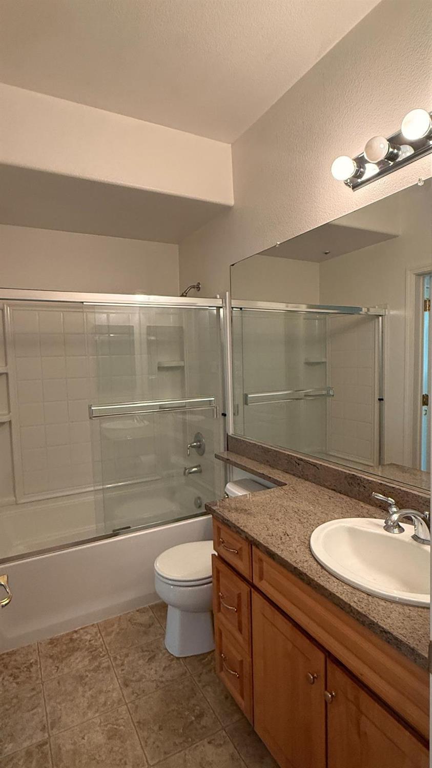 1360 Shady Lane, Unit 923 Turlock, CA 95382 - Photo 8 of 13 a bathroom with a sink a toilet and shower
