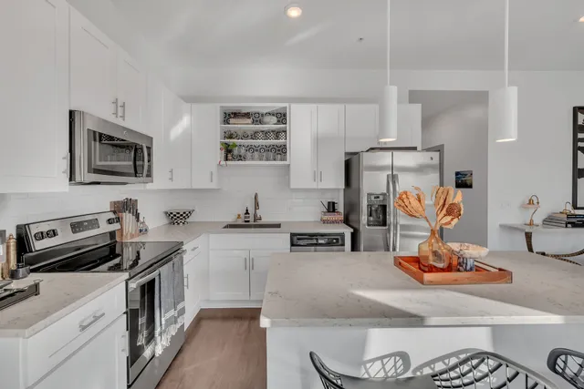 a kitchen with a sink stove and microwave