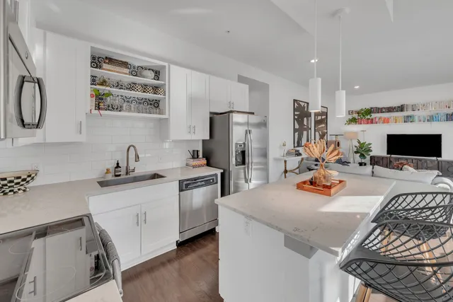 a view of a kitchen with sink dishwasher and furniture