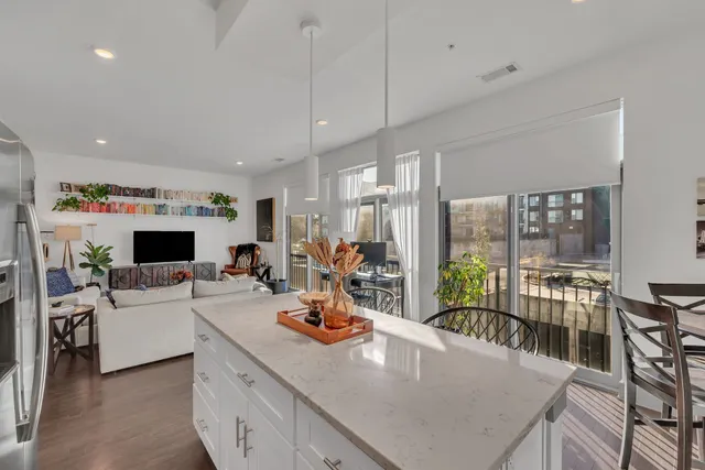 a living room with furniture a flat screen tv and a large window