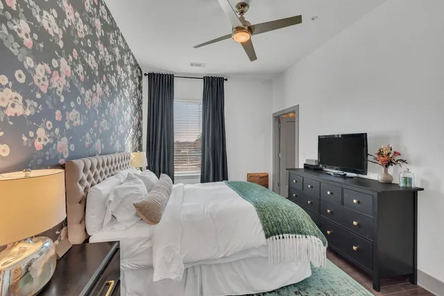 a bedroom with a bed and flat screen tv